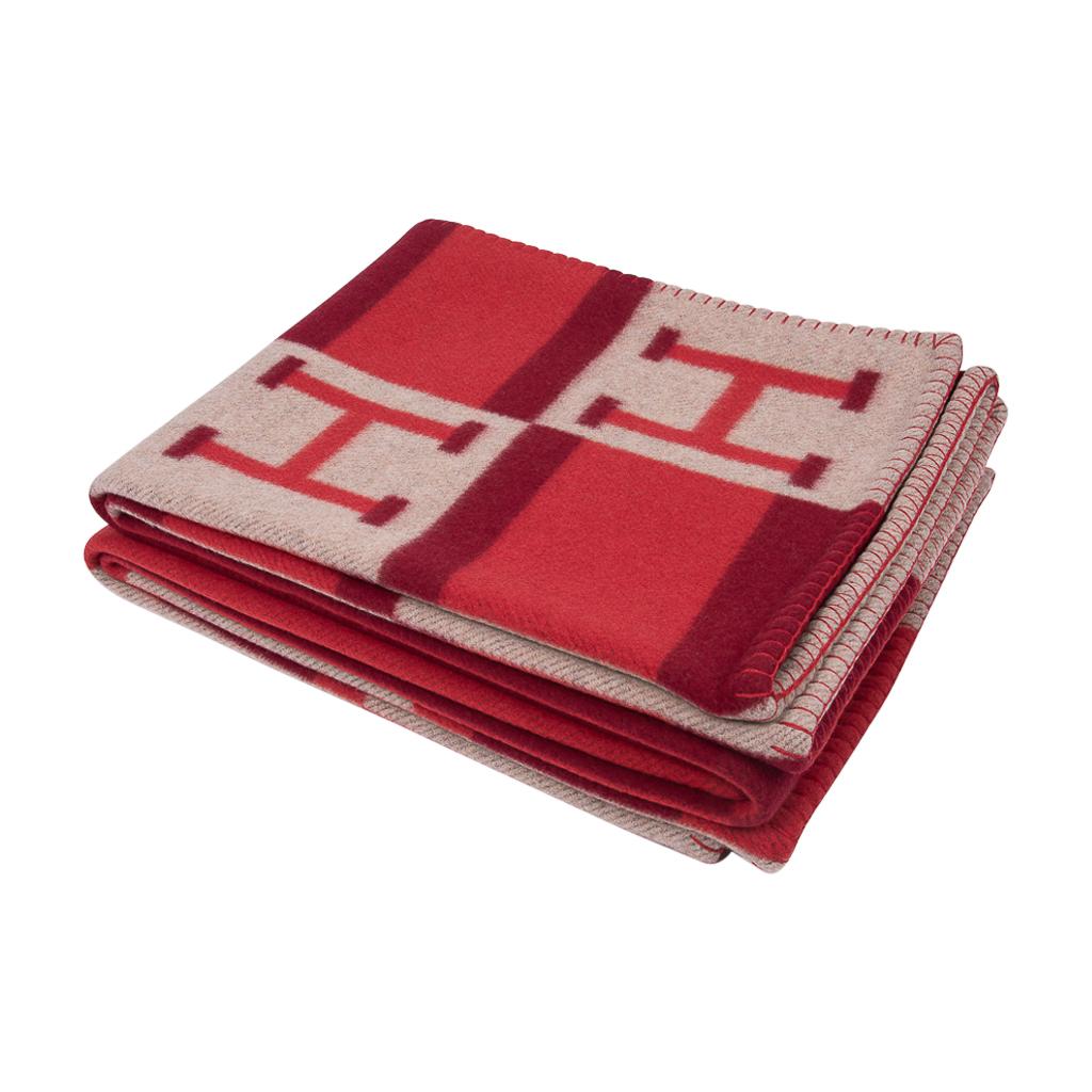 Guaranteed authentic Hermes Avalon Bayadere blanket features Rouge, Coral and Ecru.
Created from 90% Merino Wool and 10% cashmere and has whip stitch edges.
Comes with signature Hermes box.
New or Pristine Store Fresh Condition. 
**Please see the