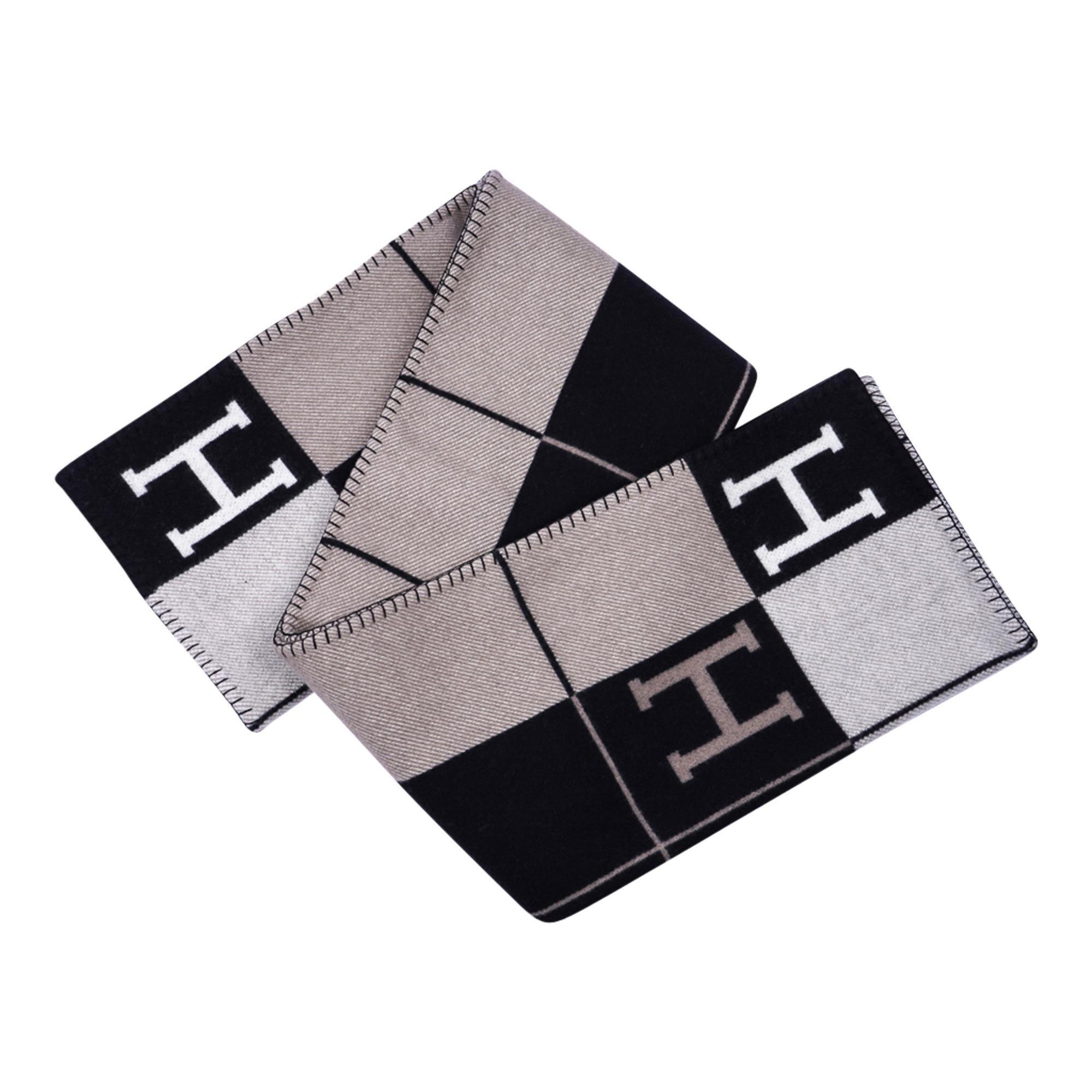 Mightychic offers an Hermes classic Avalon III signature H blanket featured in rare Black, Camel and Ecru.
Created from 90% Merino Wool and 10% cashmere and has whip stitch edges.
New or Pristine Store Fresh Condition. 
Unparalleled for 21 years in