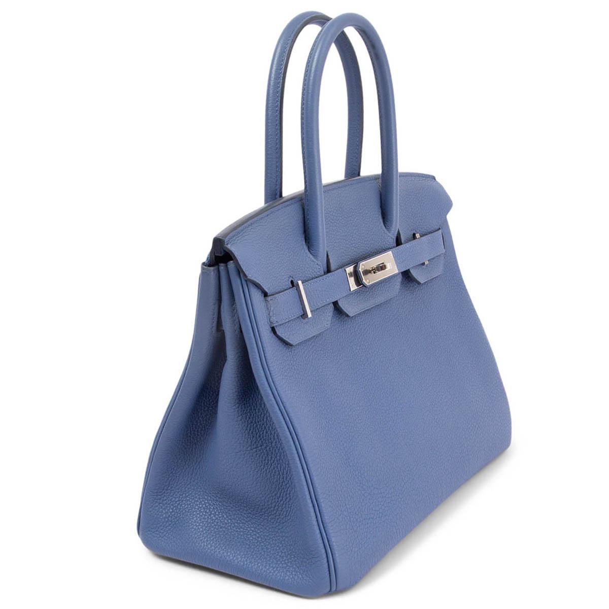 100% authentic Hermès Birkin 30 bag in Brighton blue Togo leather with palladium hardware. Lined in Chevre (goat skin) with an open pocket against the front and a zipper pocket against the back. Has been carried with darkening to the underside of