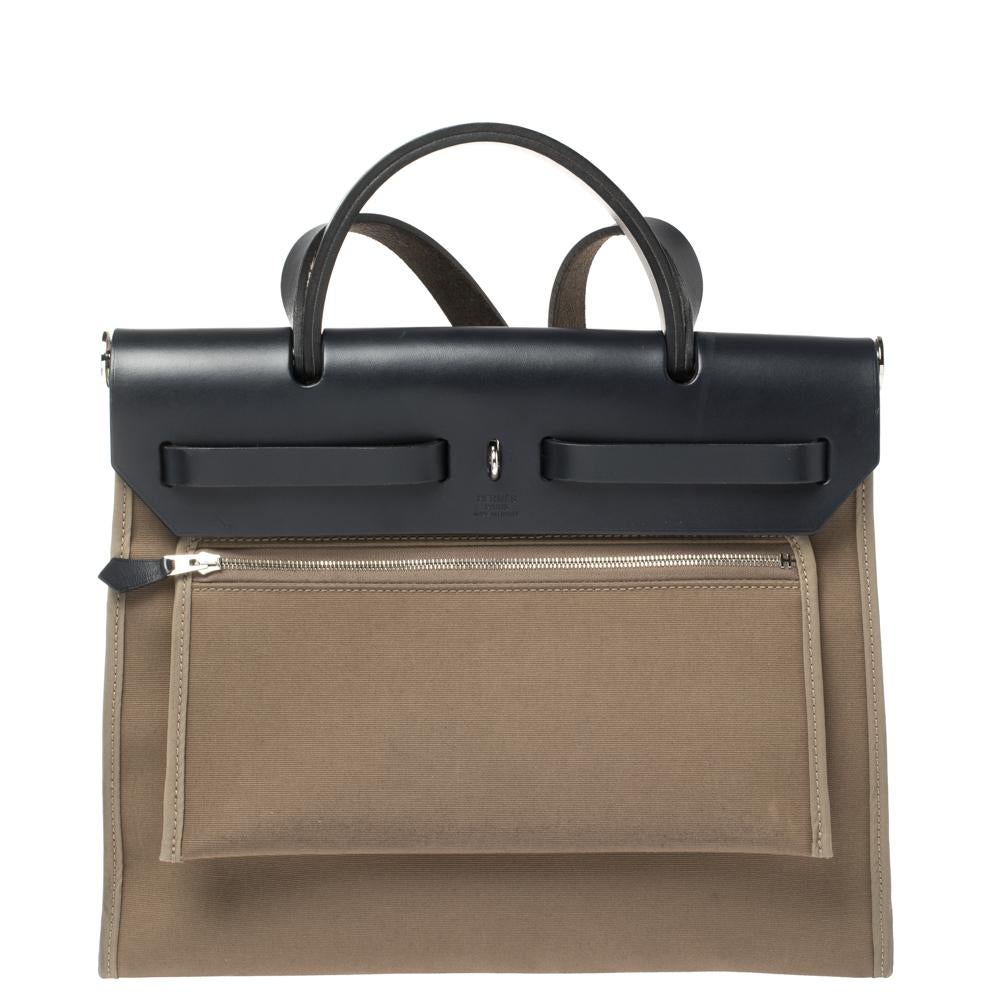 Made from brown canvas and leather, the Herbag Zip is just as outstanding as all of Hermes' other handbags. First introduced in 2009 as a new version of the Herbag, this piece comes with a single handle, a long shoulder strap and it flaunts fabulous