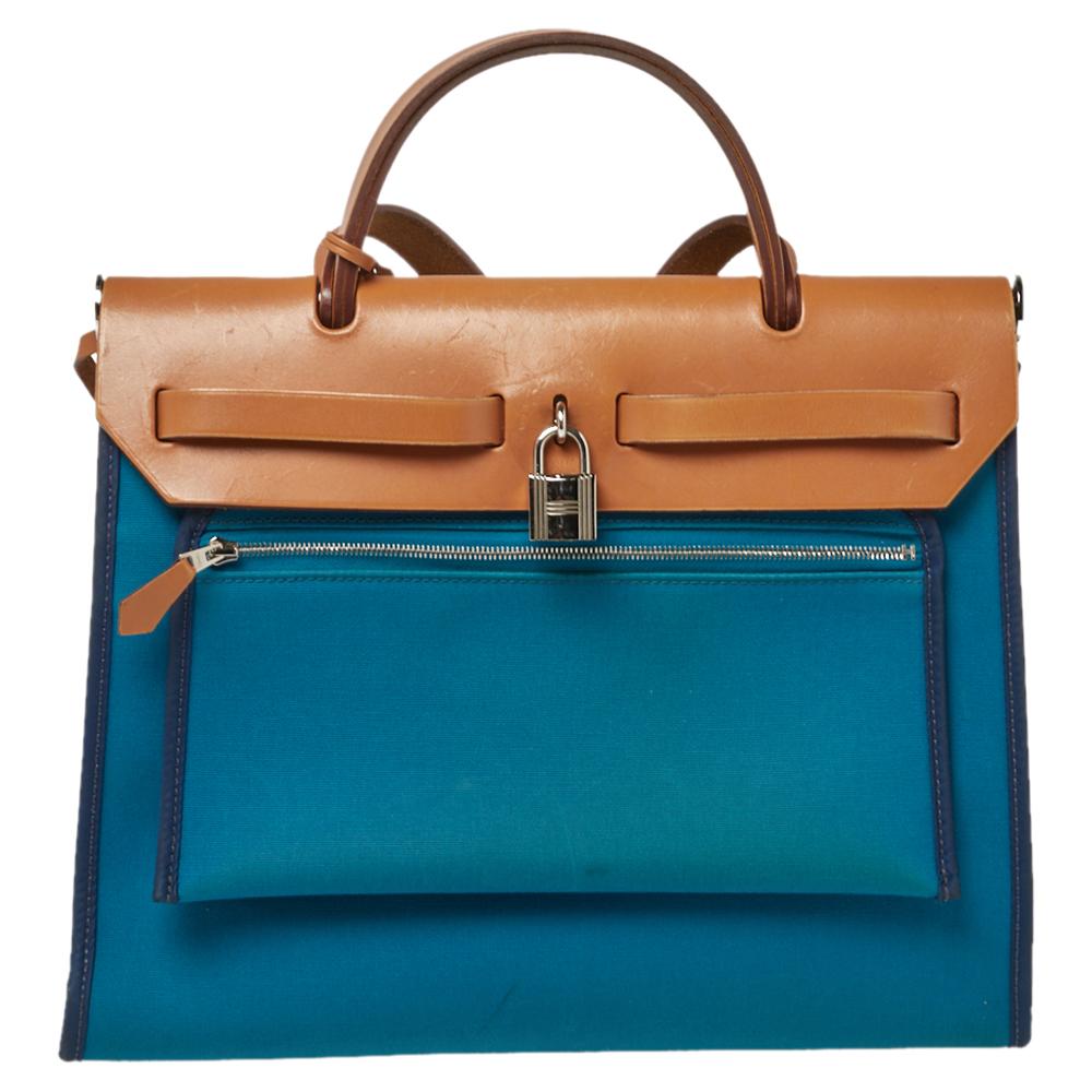 Made from blue canvas and leather, the Herbag Zip is just as outstanding as all of Hermes' other handbags. First introduced in 2009 as a new version of the Herbag, this piece comes with a single handle, a long shoulder strap and it flaunts a