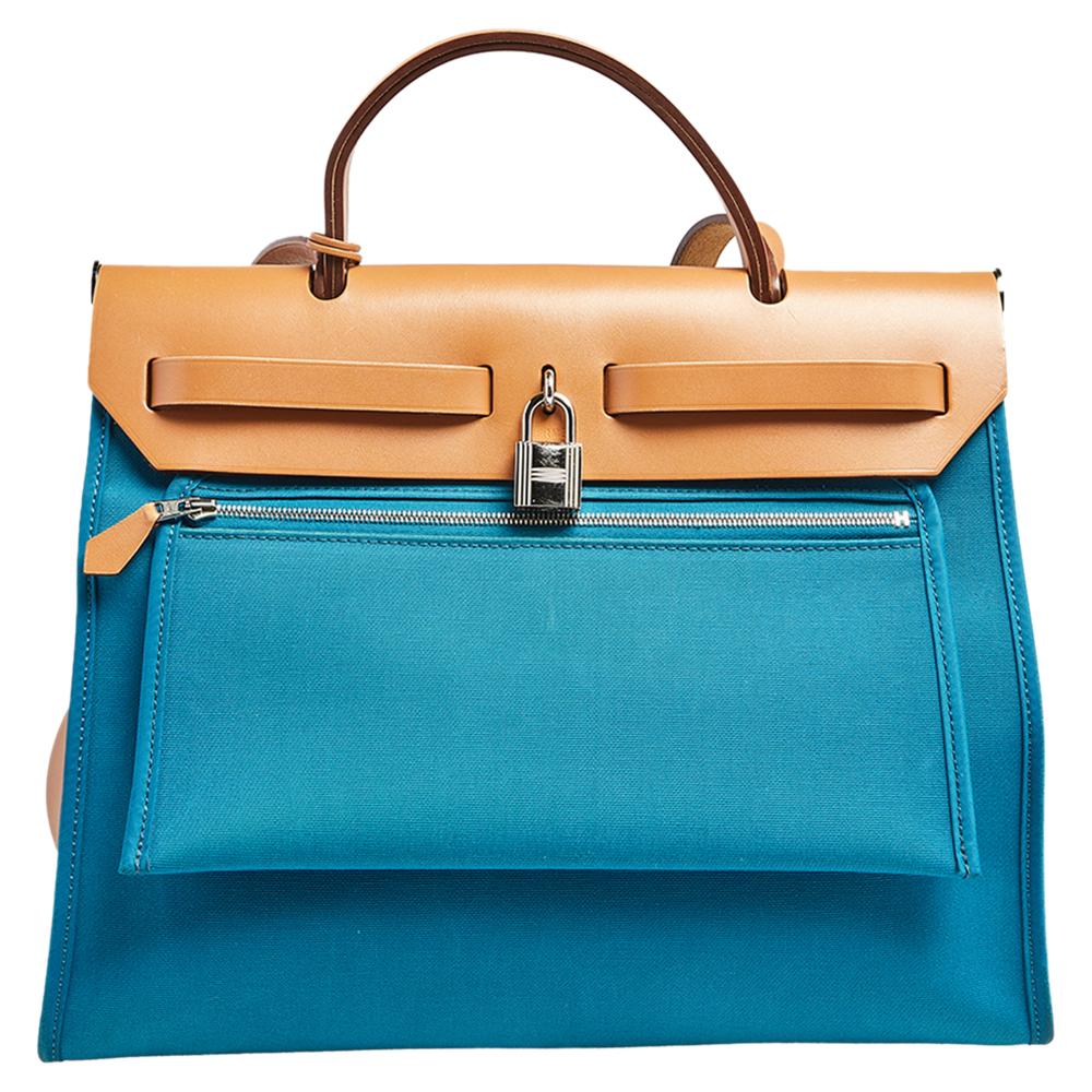 Made from blue canvas and leather, the Herbag Zip is just as outstanding as all of Hermes' other handbags. First introduced in 2009 as a new version of the Herbag, this piece comes with a single handle, a long shoulder strap and it flaunts a