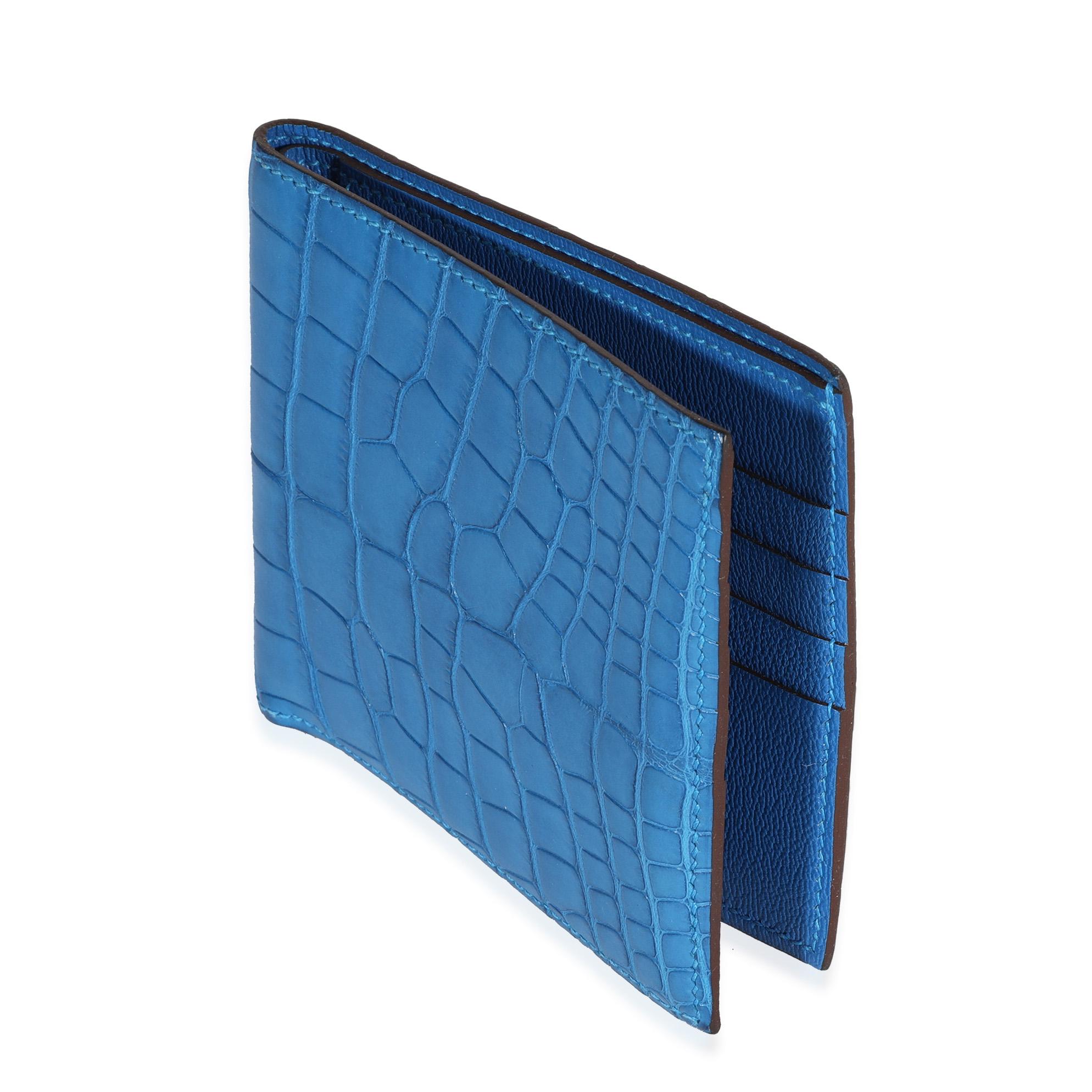 Listing Title: Hermès Bleu Mykonos Matte Alligator MC2 Copernic Wallet
SKU: 117744
MSRP: 4750.00
Condition: Pre-owned 
Handbag Condition: Never Worn
Condition Comments: Please note: this item can not be shipped to all areas.
Brand: Hermès
Model: MC2