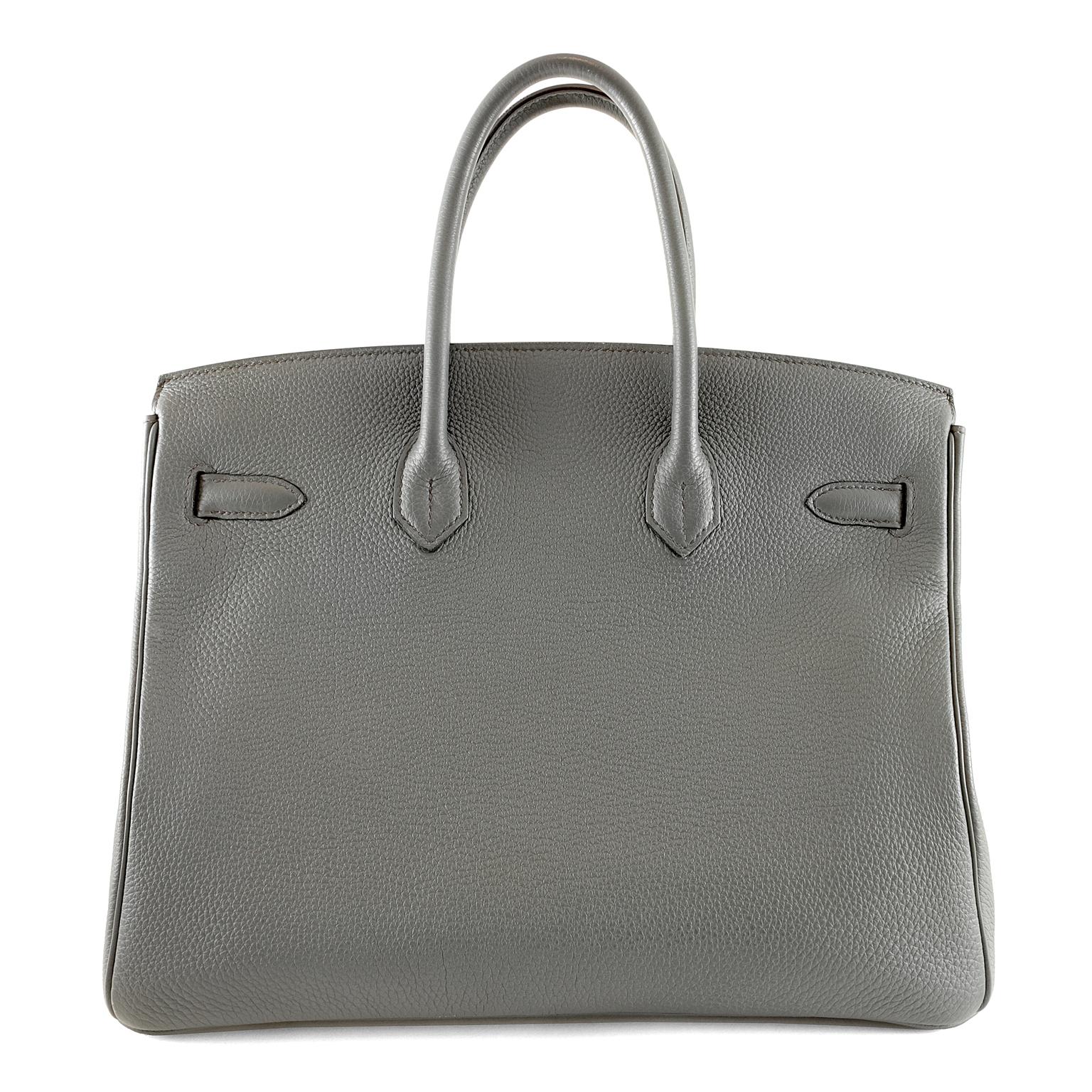 Hermès Bleu Orage Clemence 30 cm Birkin - pristine condition; appears never carried. 
Hermès bags are considered the ultimate luxury item the world over.  Hand stitched by skilled craftsmen, wait lists of a year or more are common.  Bleu Orage, a