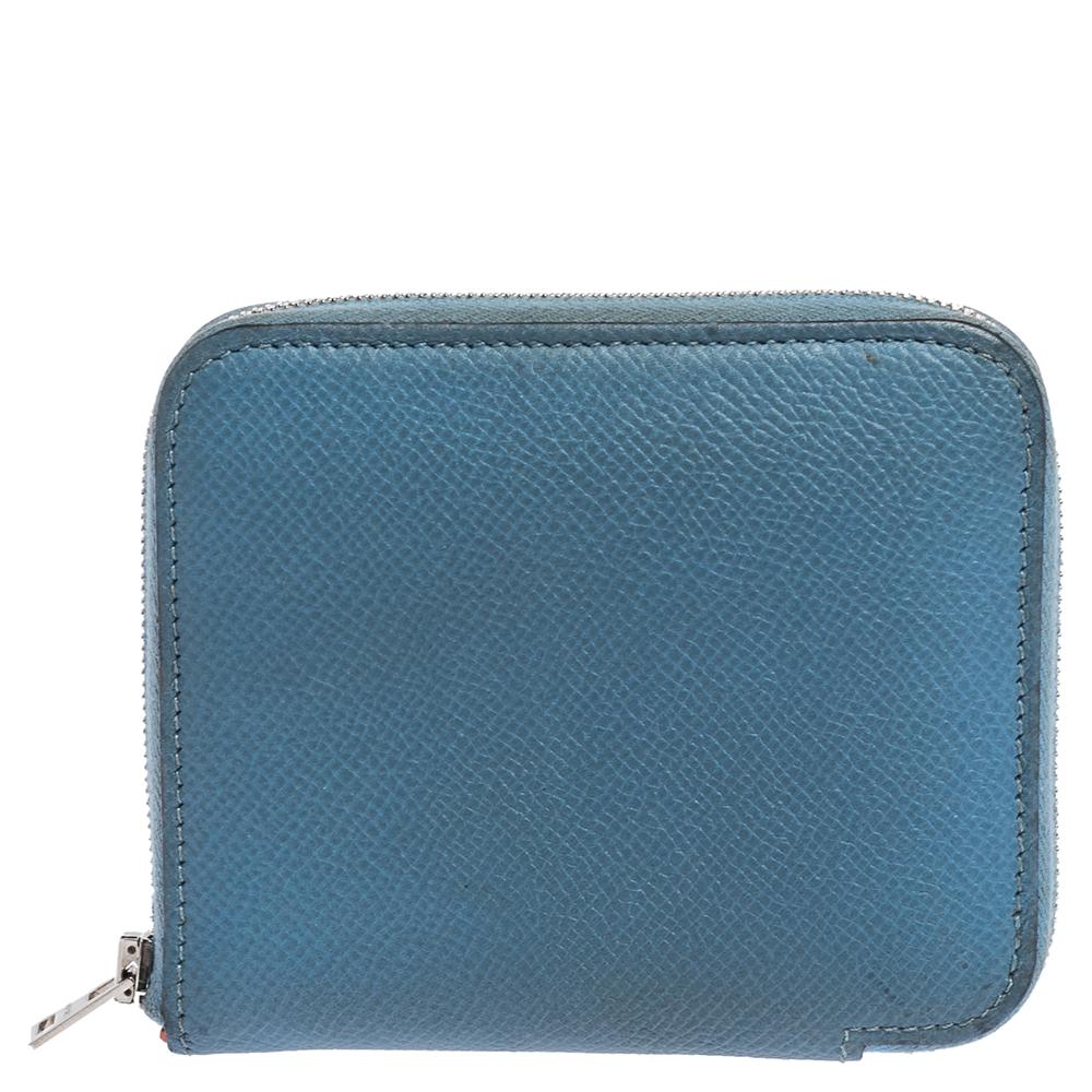 The Azap compact wallet by Hermes in Epsom leather brings a luxurious appeal and high quality. The wallet has slots for your cards, a zip pocket for your coins, and open compartments.

