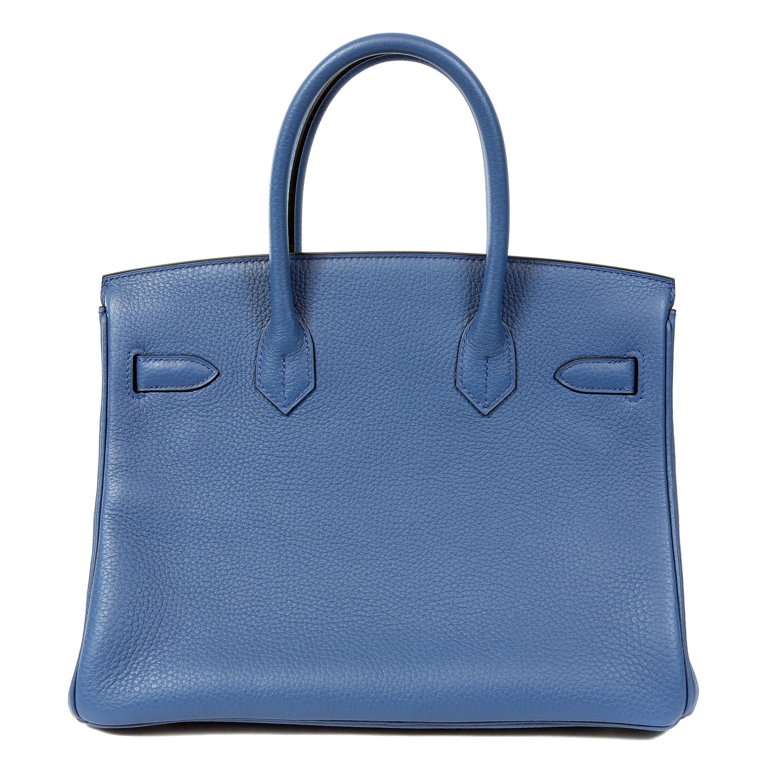 This authentic Hermès Bleu Saint Cyr Clemence 30 cm Birkin is in pristine condition; never before carried.  Hermès bags are considered the ultimate luxury item the world over.  Hand stitched by skilled craftsmen, wait lists of a year or more are