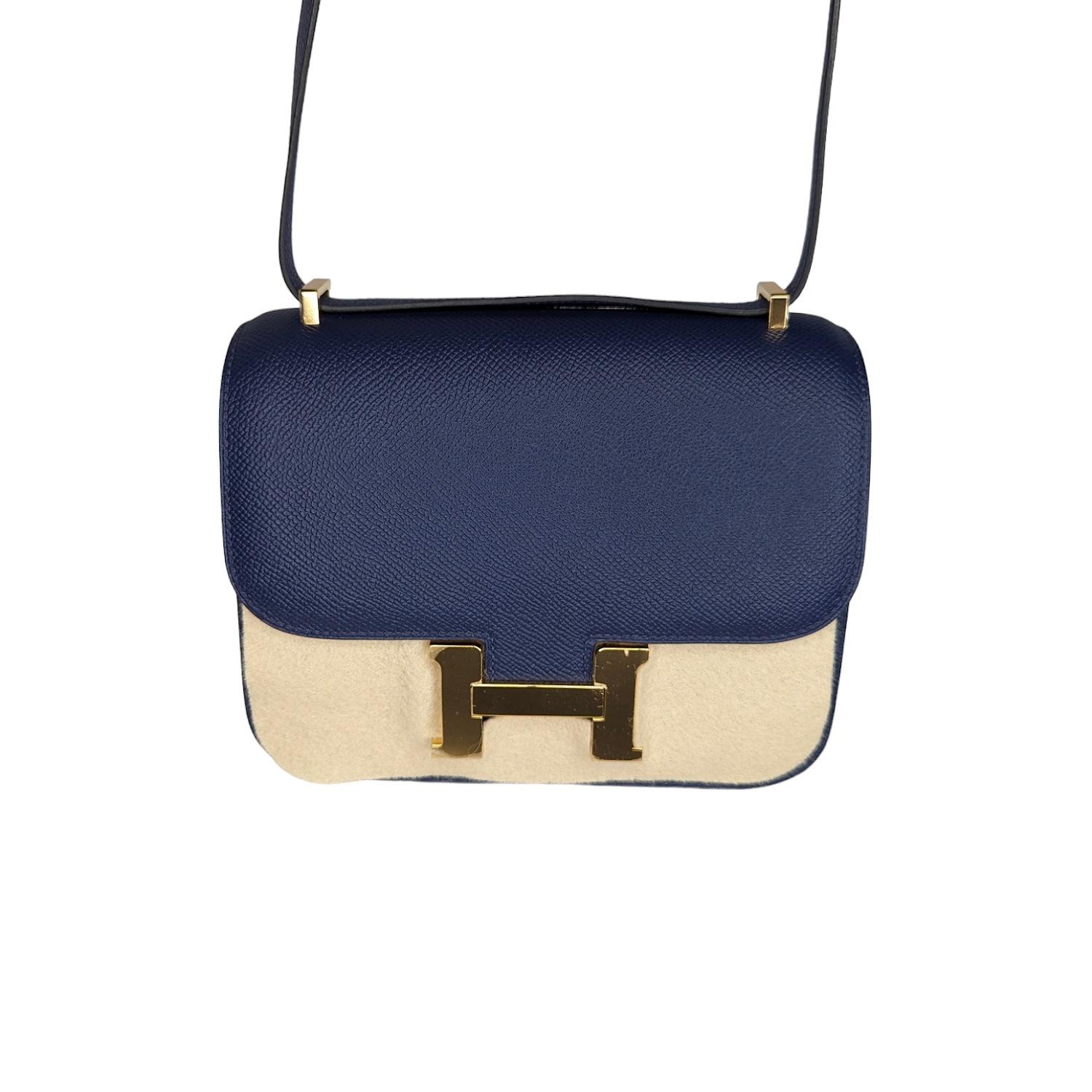 This stylish shoulder bag is finely crafted of Epsom leather in Bleu Saphir. The bag features a long shoulder strap with gold plated hardware including an H buckle at the flap. This opens to a compact partitioned Agneau lambskin leather interior