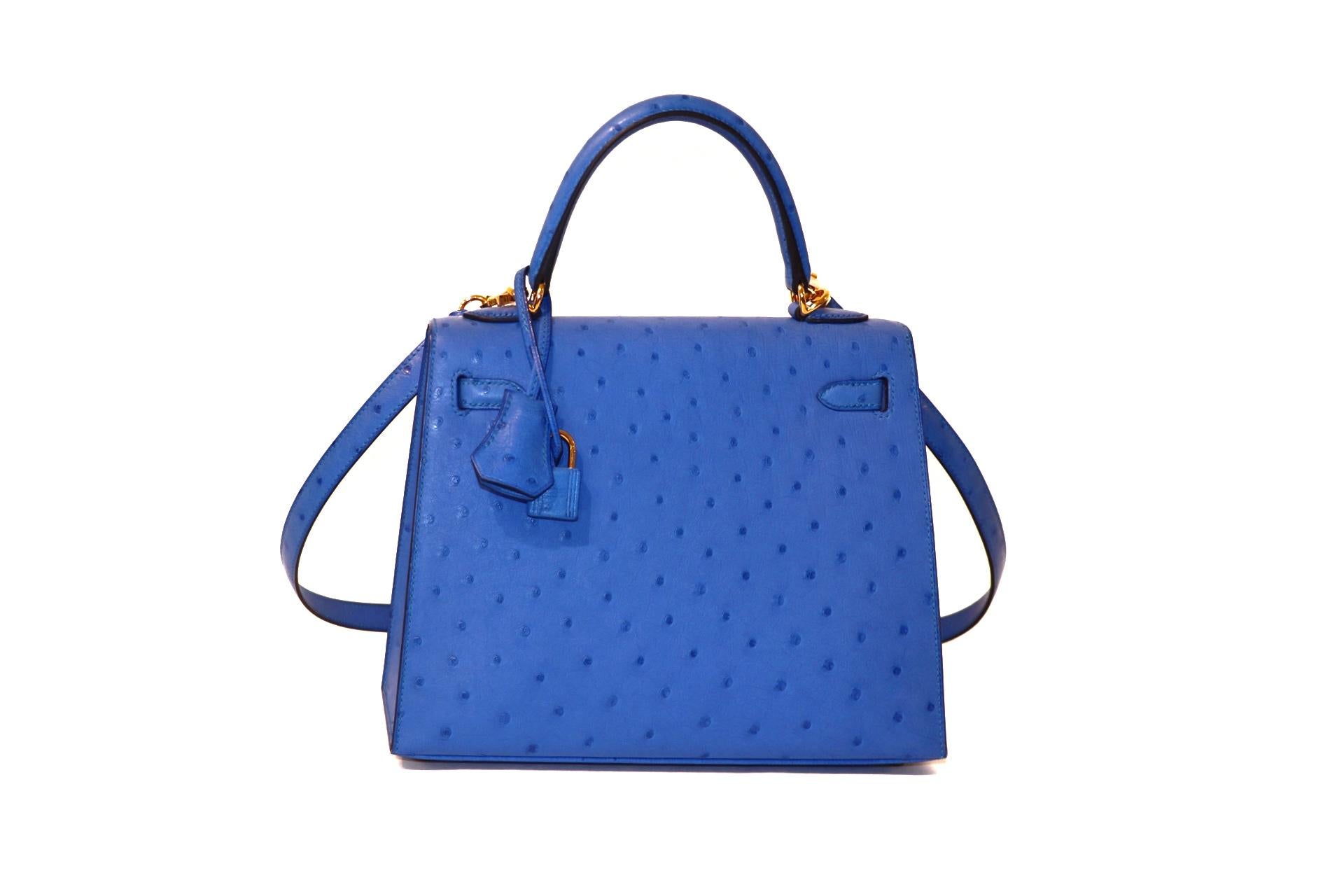 This authentic Hermès Bleuet Ostrich 28 cm Kelly is in PRISTINE unworn condition.  The protective plastic remains intact on the hardware.   Hermès bags are considered the ultimate luxury item worldwide.  Each piece is handcrafted with waitlists that