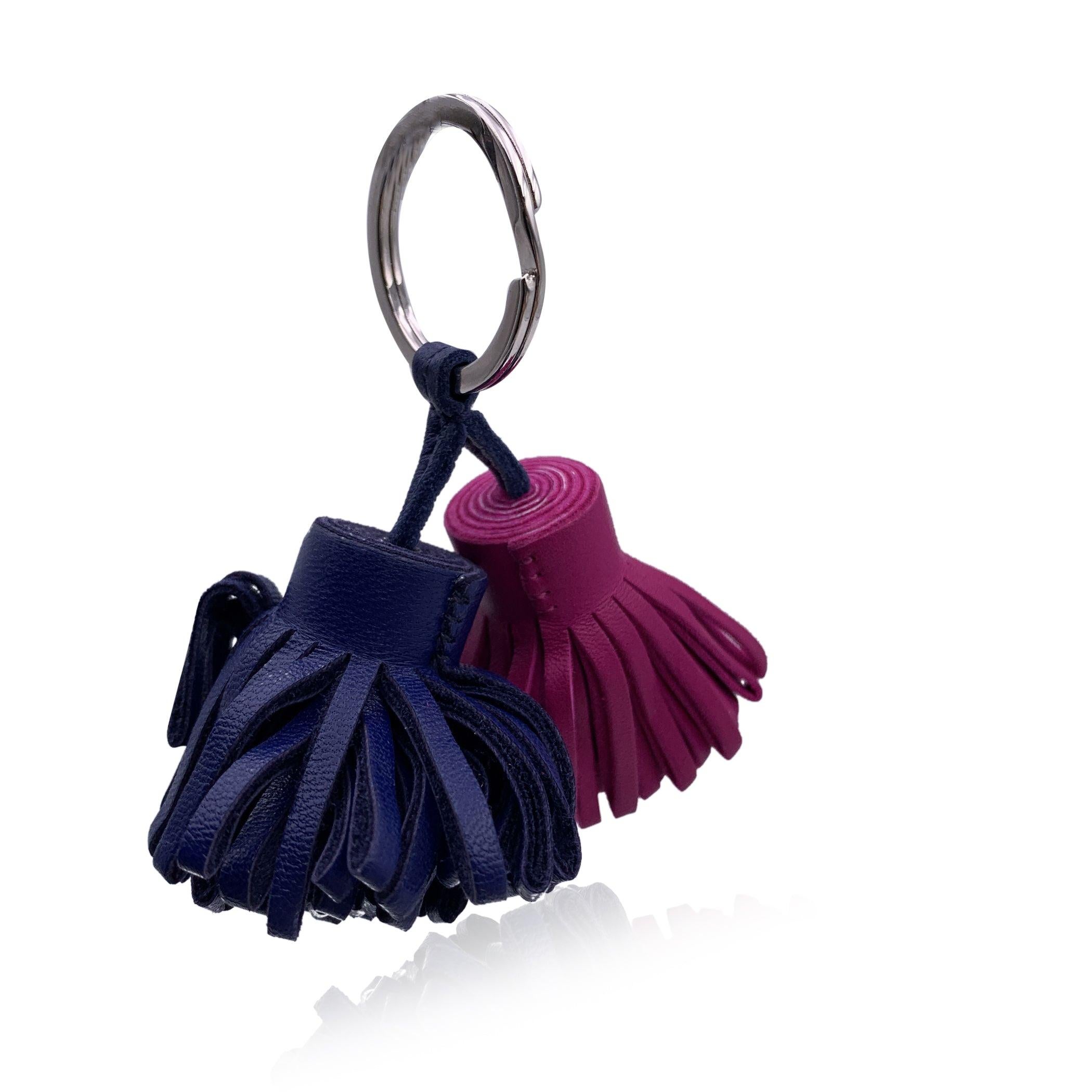 Hermès 'Carmen Uno-Dos' key ring. 2 small tassels crafted in electric bue and pink purple Milo Lambskin leather. Palladium plated hardware. 'HERMES Paris' engraved on the ring and on leather tassel. Retail price is about 350 euros Condition A -