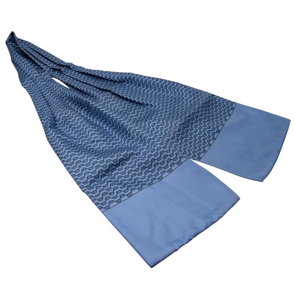 Hermès Blue Ascot France Silk Necktie Monogram Pattern Interlocking Scarf/ Wrap

Hermes the master of craftsmanship and luxury. The ascot originated in England during the late 19th century, and it got its name from the horserace called the 'Royal