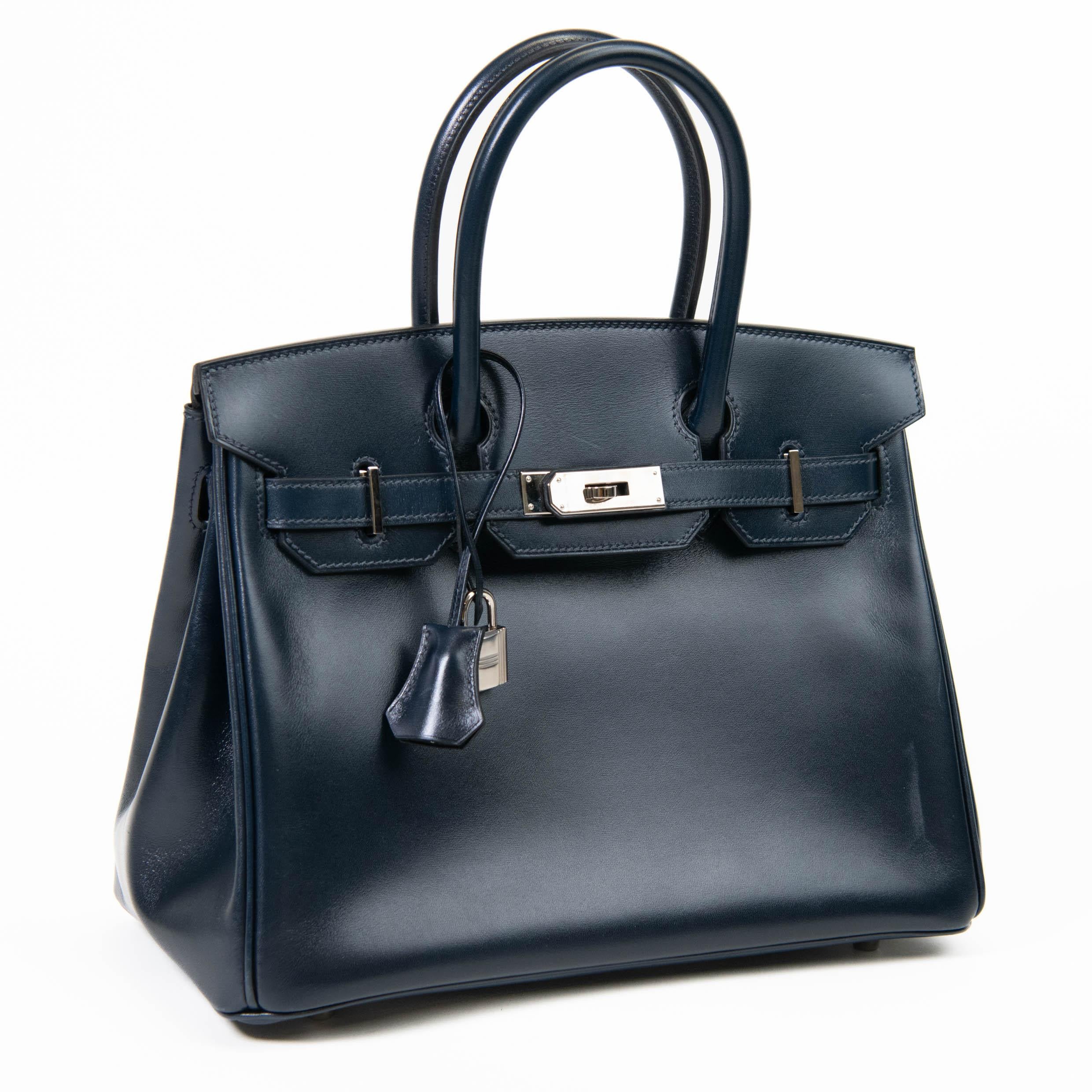 100% Authentic

This classic handbag is beautifully crafted of supple box calfskin leather in blue. The bag features rolled leather top handles, a frontal flap and strap closure and gold-plated hardware including a turn lock and keys in the