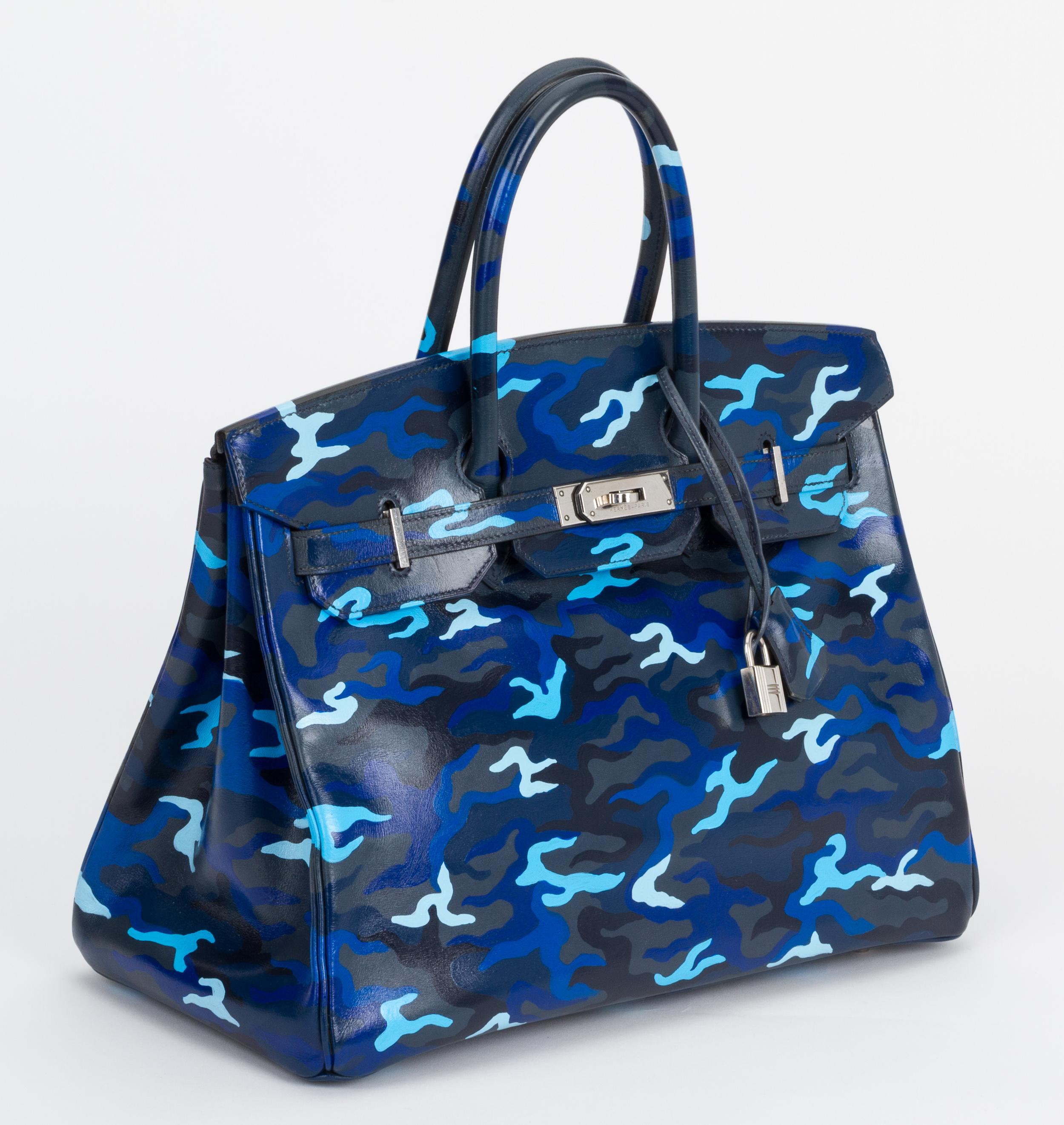 Hermes birkin 35 in blue box calf leather with palladium hardware. The bag has been professionally painted by an artist in camouflage design in various shades of blue. One of a kind handbag. Date stamp E for 2001. Comes with original dust cover.