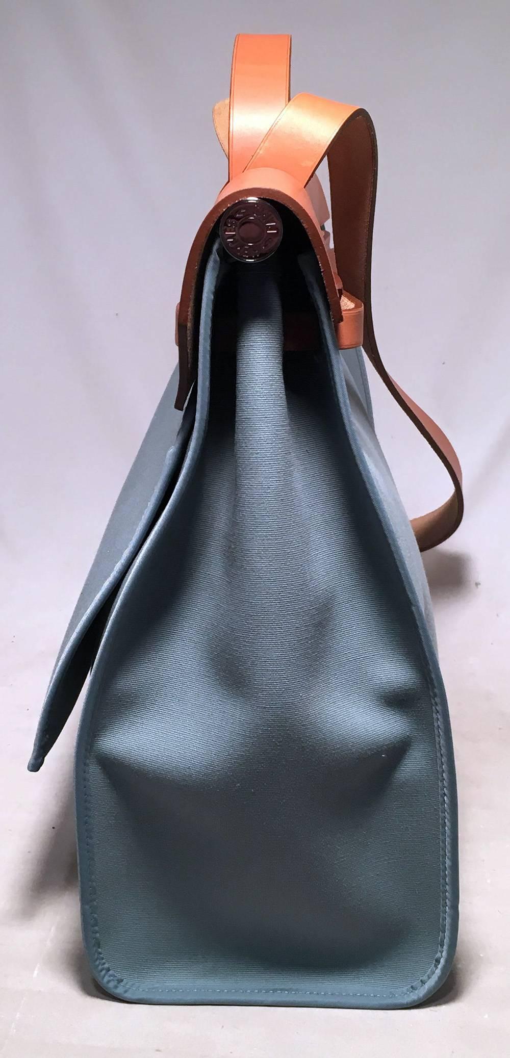 Hermes Blue Canvas Toile Herbag Tote in excellent condition.  Blue toile canvas exterior trimmed with palladium silver hardware and tan barenia leather.  Back side exterior zippered pocket for added storage. Double strap stop flap closure opens to a