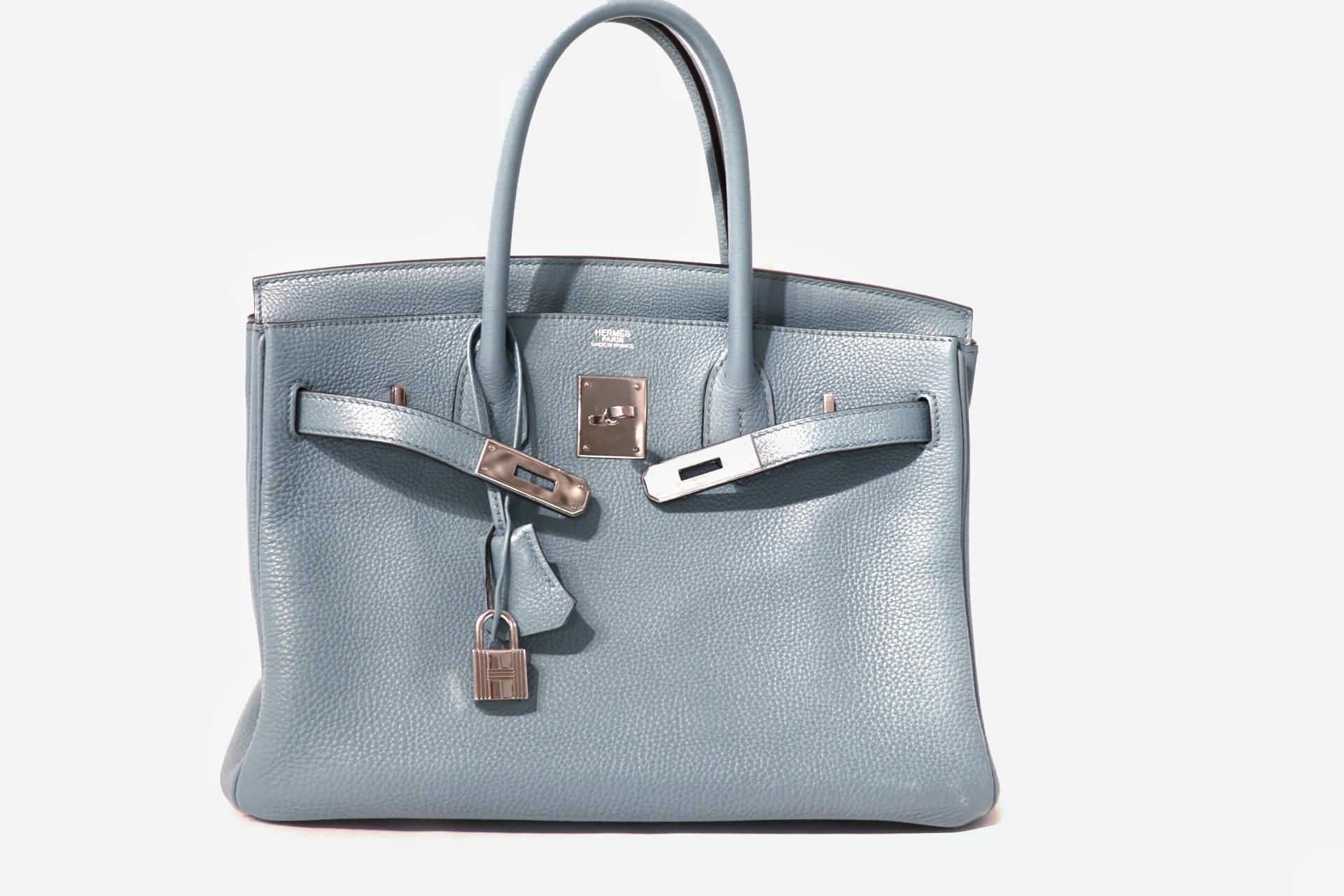 This authentic Hermès Bleu Ciel Togo 30 cm Birkin is in excellent condition.    Hand stitched by skilled craftsmen, wait lists of a year or more are common for the Hermès Birkin. They are considered the ultimate in luxury fashion. Bleu Ciel, a pale