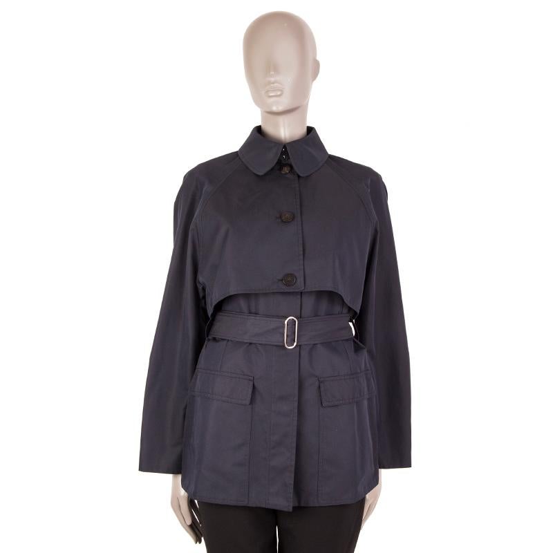 Hermés two-piece trench coat (long vest and cropped jacket) in midnight blue cotton (65%) and polyamide (35%). The cropped jacket has a flat collar, raglan sleeves, a box pleat on the back and a two-buttoned cuffs to sinch. Closes with three buttons