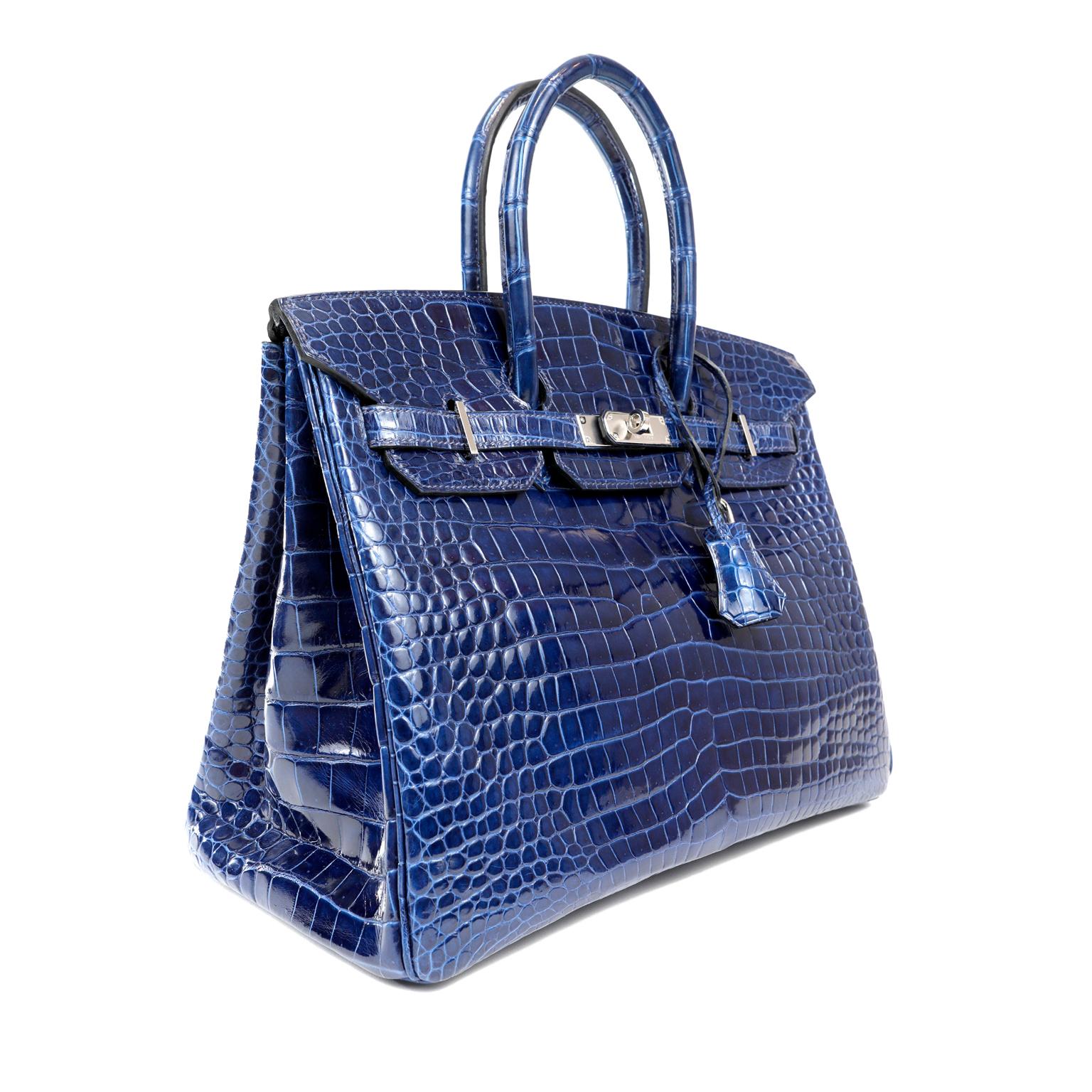 This authentic Hermès Blue Crocodile 35 cm Birkin is in pristine  unworn condition with the protective plastic intact on the hardware.   Hermès bags are considered the ultimate luxury item the world over.  Hand stitched by skilled craftsmen, wait