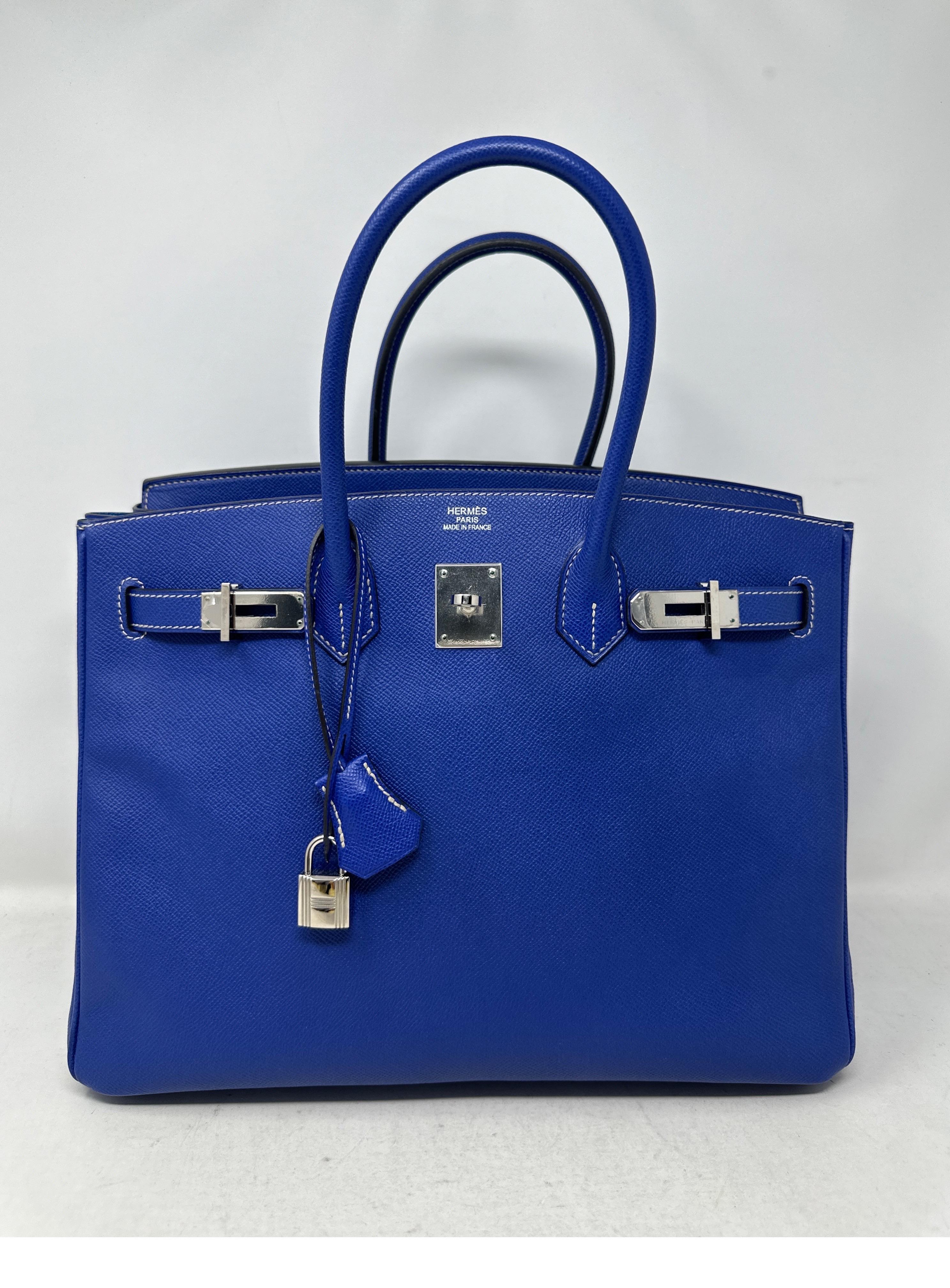 Hermes Blue Electrique Birkin 35 Bag. Palladium silver hardware. Epsom leather. Candy Birkin. Interior blue mykonos and exterior color is blue electrique. Excellent condition. Plastic is still on the hardware. Includes clochette, lock, keys, and