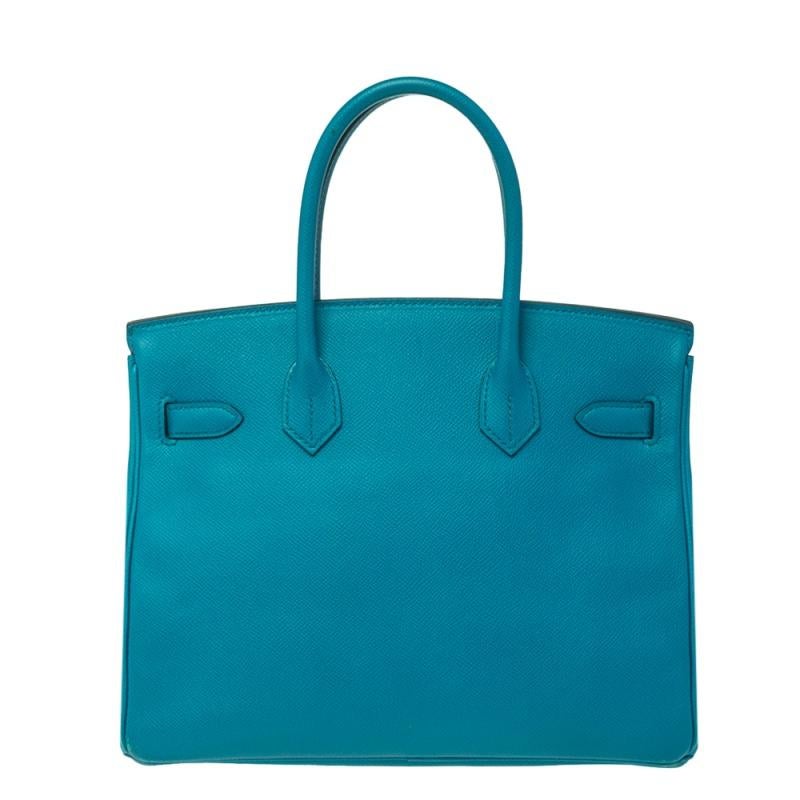If you've been wishing to own an authentic Birkin bag, there is no better time to buy this coveted work of art than now. Here, we have this blue Izmir Birkin 30 just for you. Crafted in France from Epsom leather, the bag features dual top handles