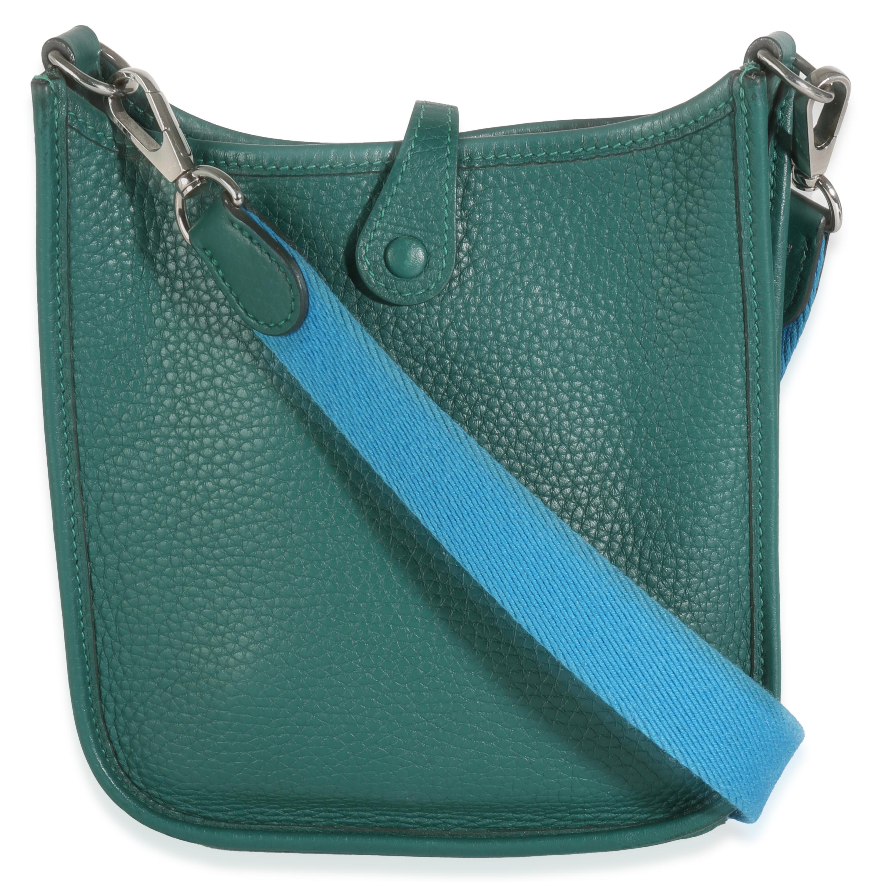 Listing Title: Hermès Blue Izmir Malachite Clemence Mini Evelyne TPM PHW
SKU: 142612
Condition: Pre-owned 
Condition Description: Designed in 1978 by Evelyne Bertrand, the Evelyne shoulder bag from Hermès has a distinctive aesthetic thanks to a