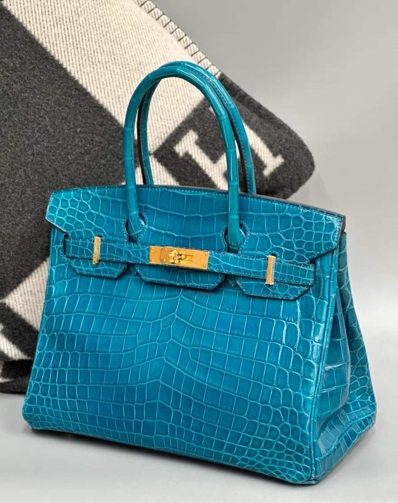 This Hermès Birkin 30cm bag is made from exotic Niloticus Crocodile skin, which originates from the Nile River and is the premier material used by Hermes. Exotic, cheerful and yet sophisticated with gold-tone hardware emphasizing the cool blue
