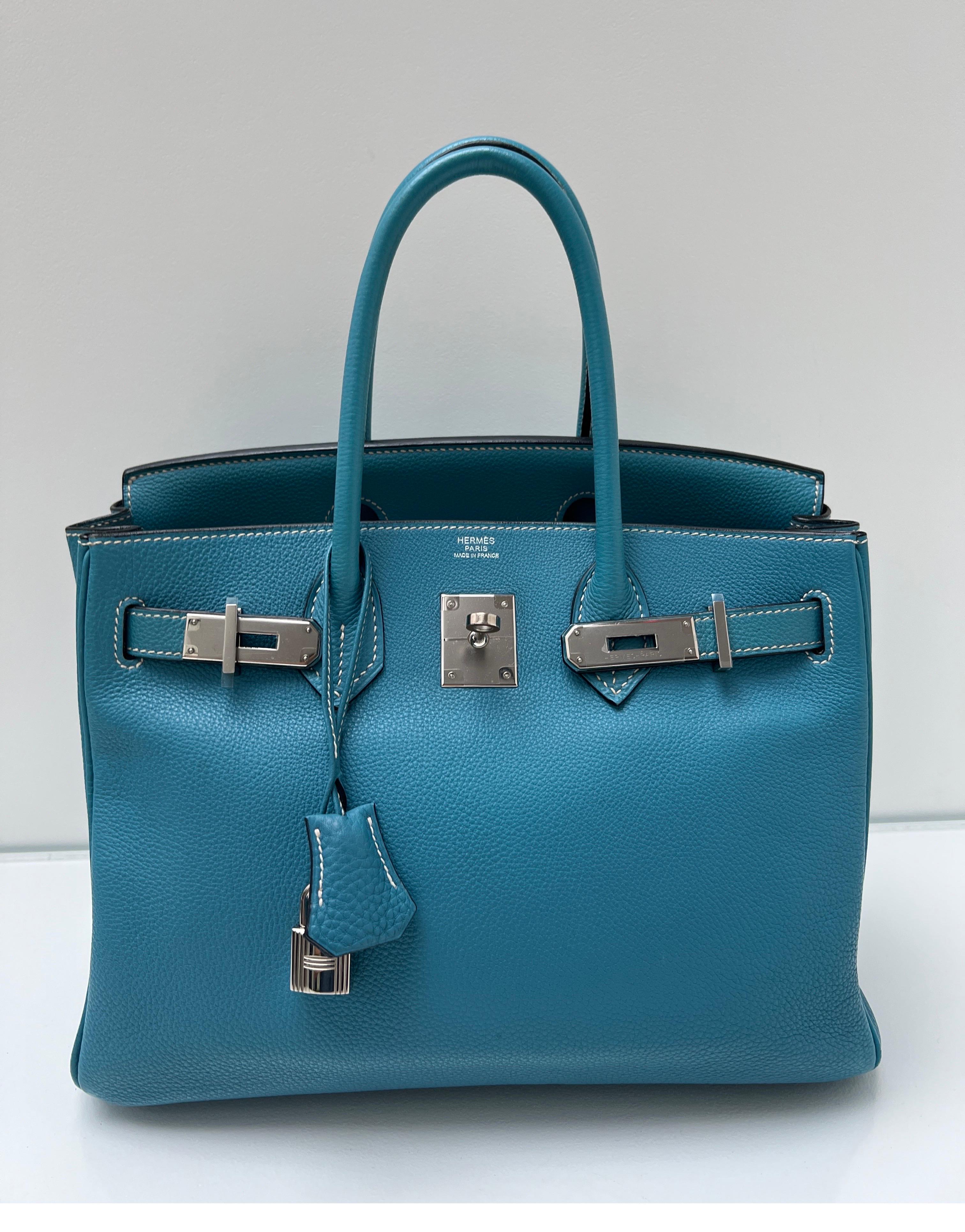 Hermes Blue Jean Birkin 30 Bag. The most wanted color of the year. Excellent condition. Plastic is still on the hardware. Interior clean. Contrast white stitching. Togo leather. Highly sought after by collectors. Most wanted size 30. Includes