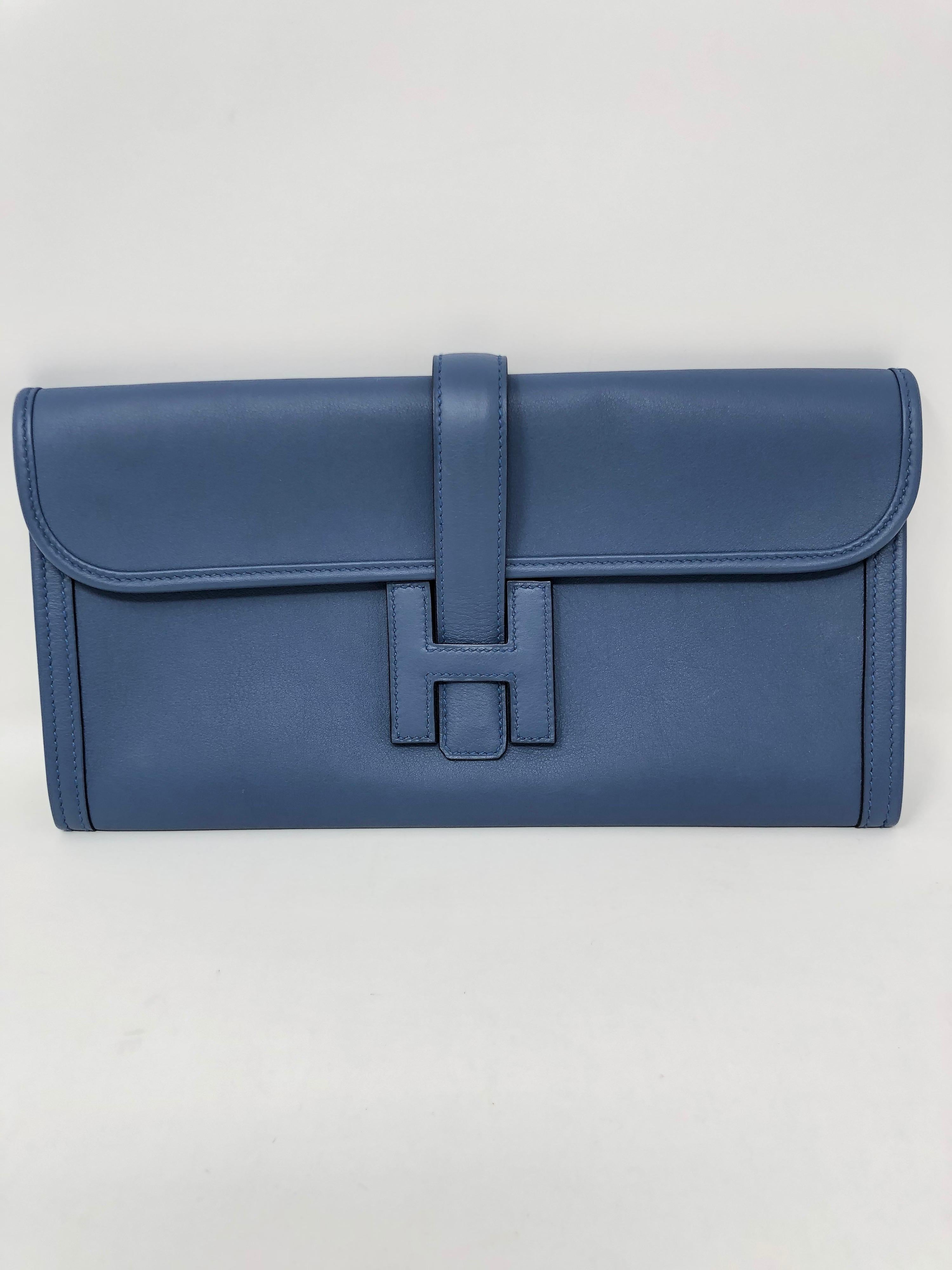 Hermes Blue Jige Clutch. Excellent condition like new. Beautiful light blue color. Hard to find color. A classic Hermes staple. Don't miss out. Guaranteed authentic. 