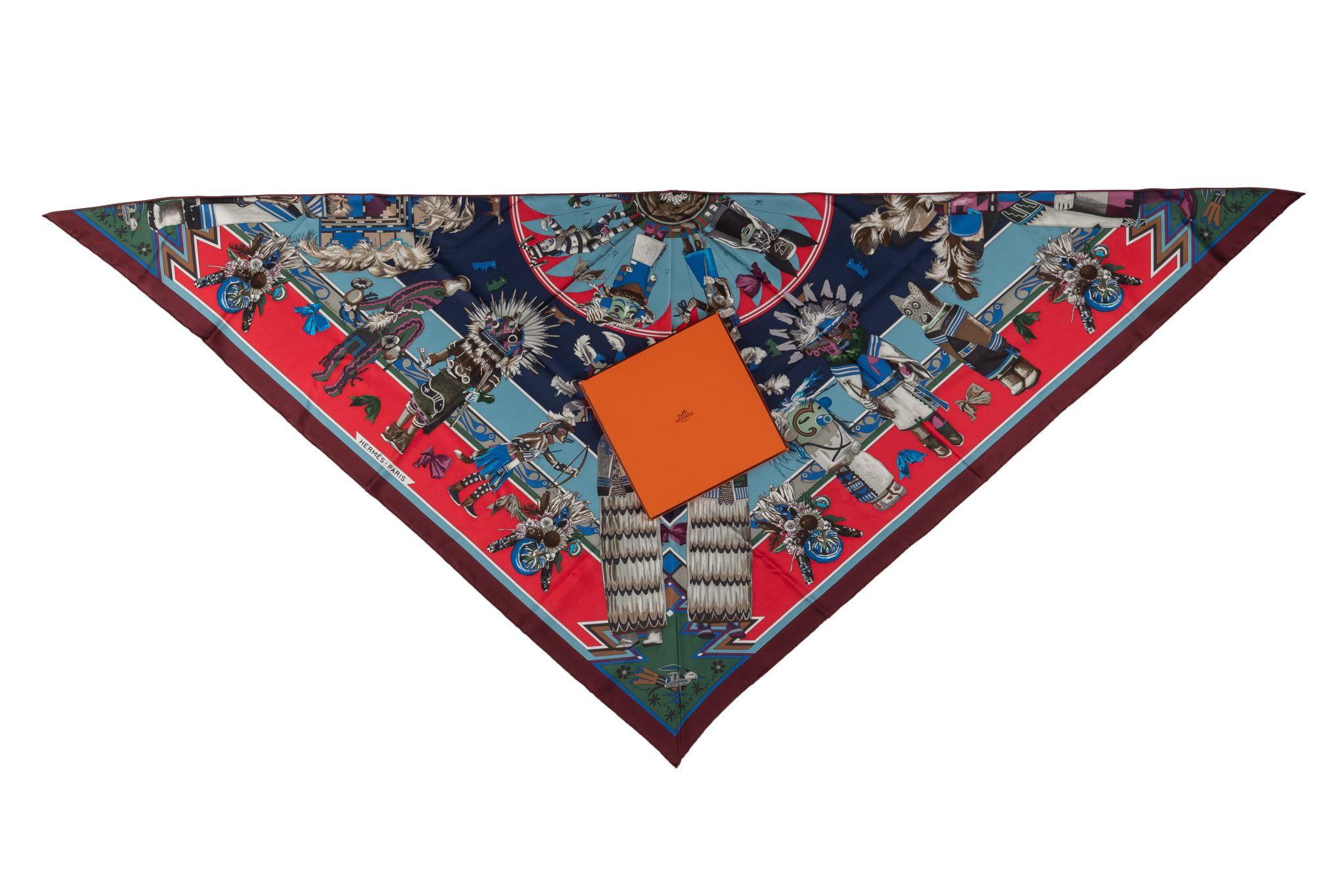 Hermès collectible kachinas pointe red and blue silk shawl in blue and red combination. Brand new in unused condition. It is made from 100% Silk with hand-rolled edges. Comes with original box.