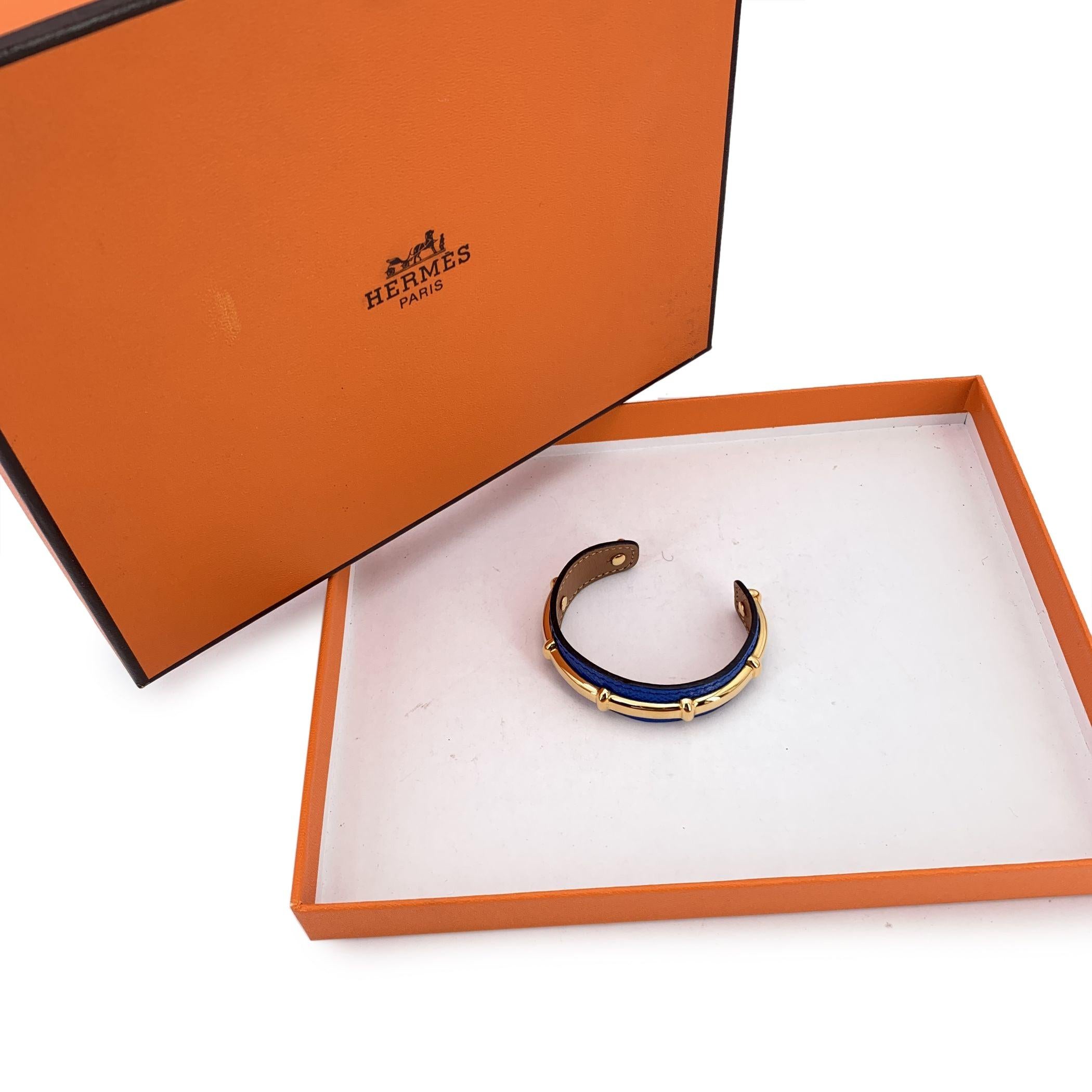 Elegant and inventive, this Hermès 'Agatha' bracelet is a refined statement piece that captures the brand's signature fusion of luxury and design. Crafted in vibrant blue leather and accented with a bamboo motif gold metal structure, it offers two