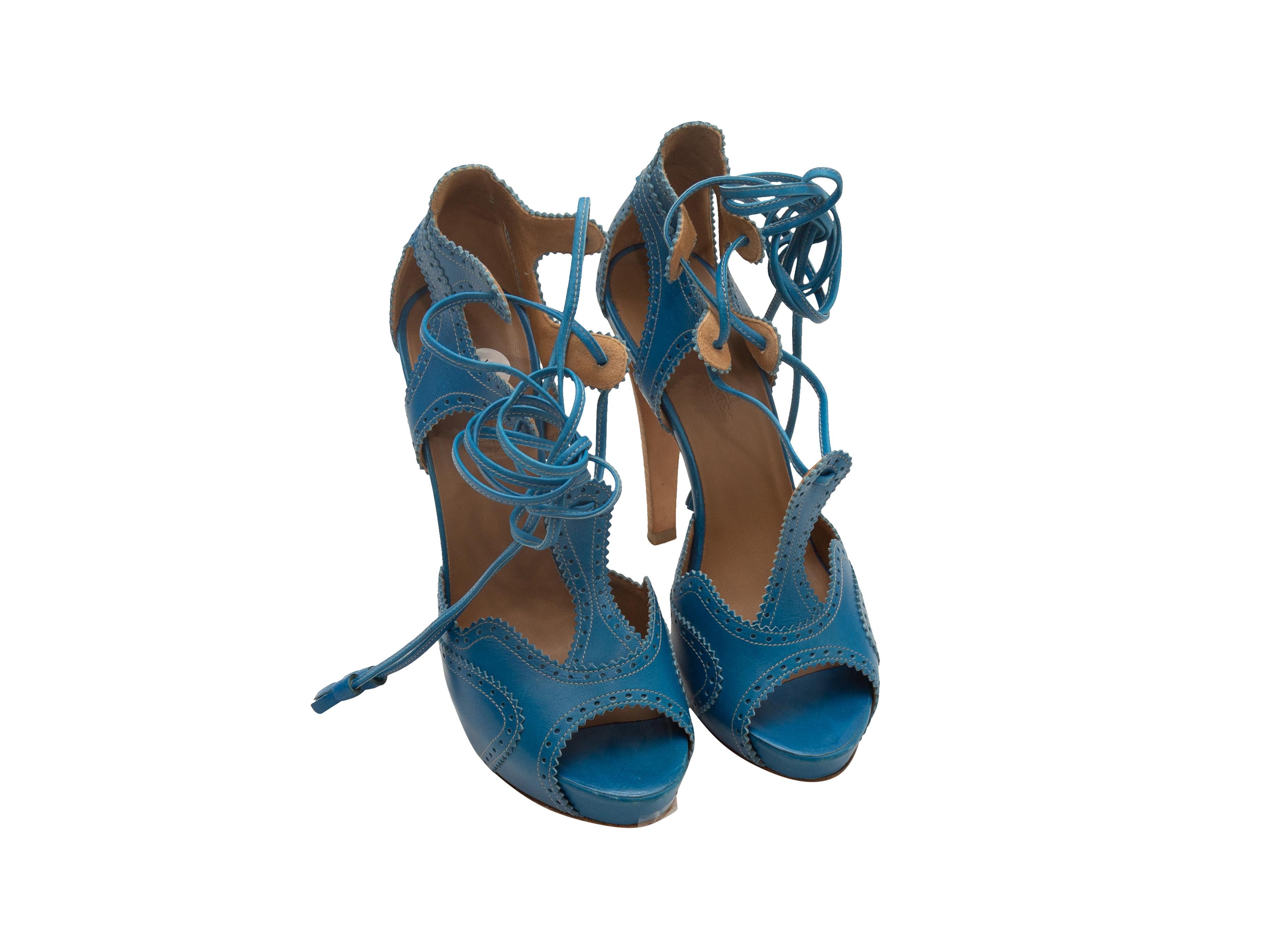 Product details: Blue leather cutout peep-toe heels by Hermes. Brogue detailing throughout. Stacked heels. Lace-up tie closures at tops. Designer size 37.5. 4.75