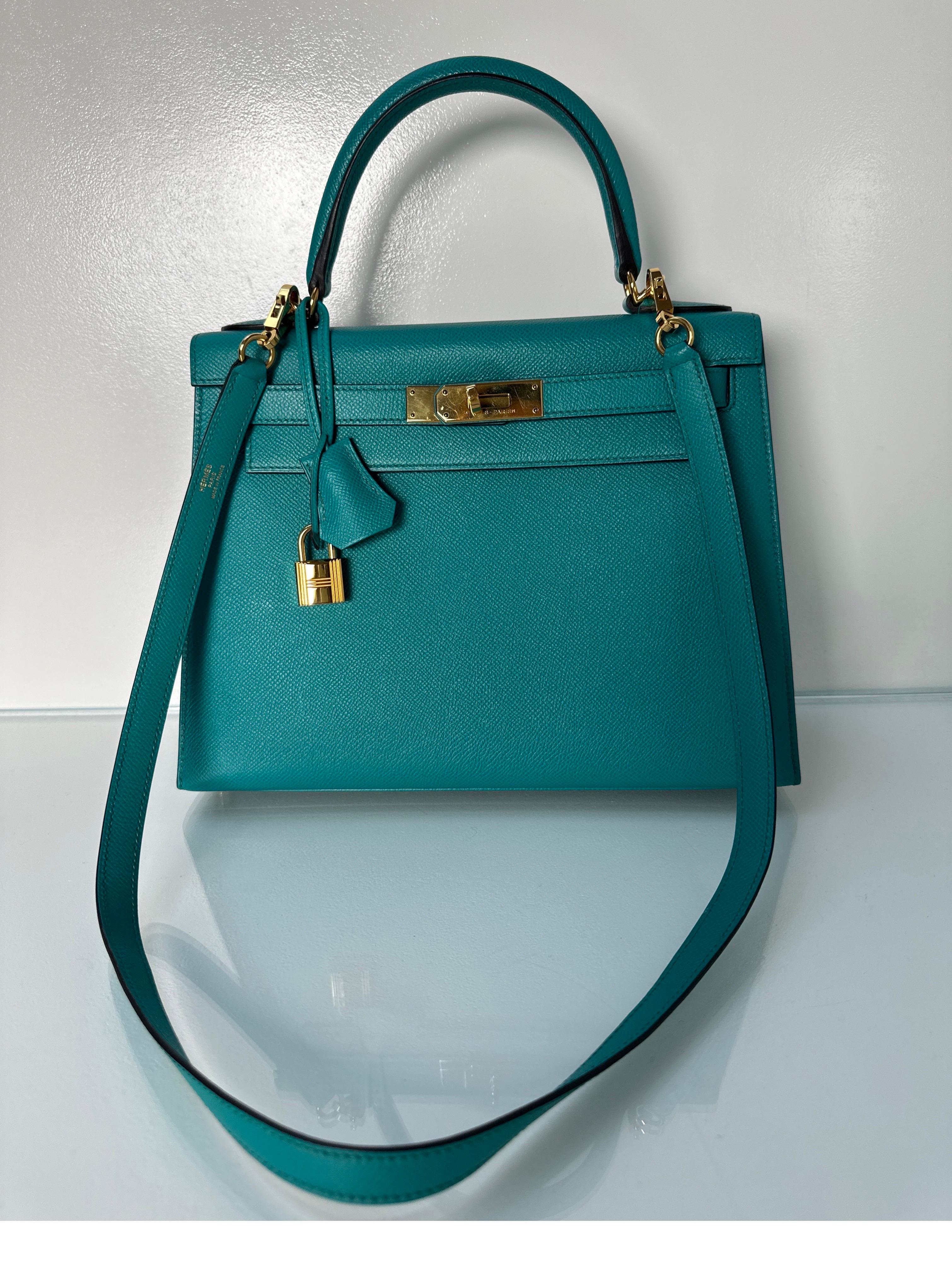 Hermes Blue Paon Kelly Bag. Stunning greenish blue color. Teal tone. Most wanted size 28 Kelly. Gold hardware. Rare combination. Interior clean. Bag looks like it was never used. Includes clochette, lock, keys, and dust bag. Guaranteed authentic.