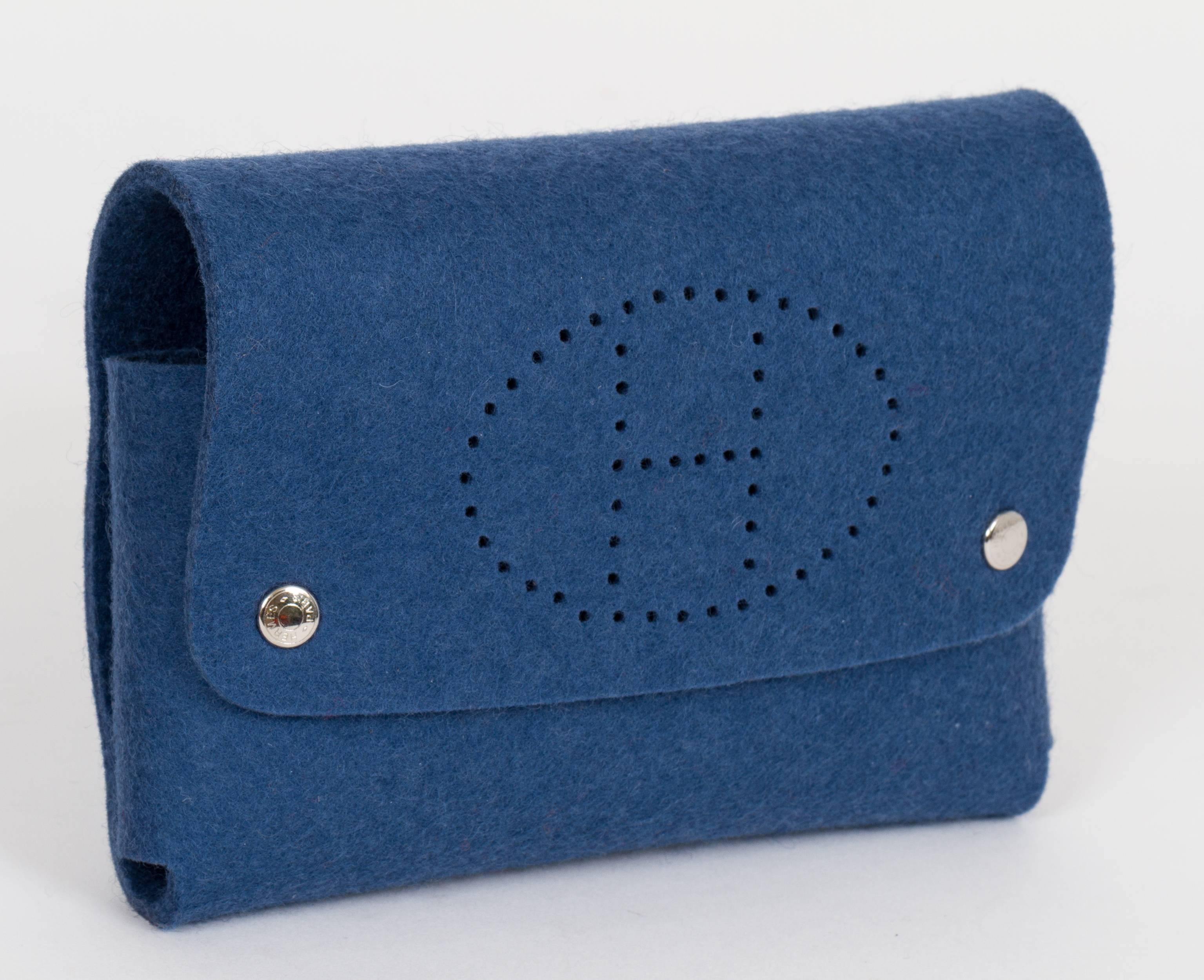 Hermès multifunctional felt pouch, with H perforated logo on front.  Cloud de selle palladium snap buttons. Poker cards holder, tissues holder. Comes with gift bag.
