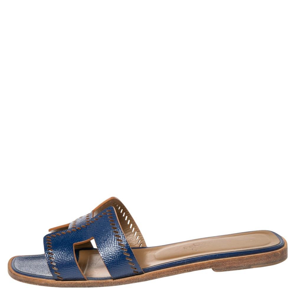 Put your best foot forward this season in these pretty Hermes sandals. These blue Oran sandals have been crafted from perforated leather in Italy and they feature the iconic H on the vamps as well as insoles meant to provide comfort at every step.