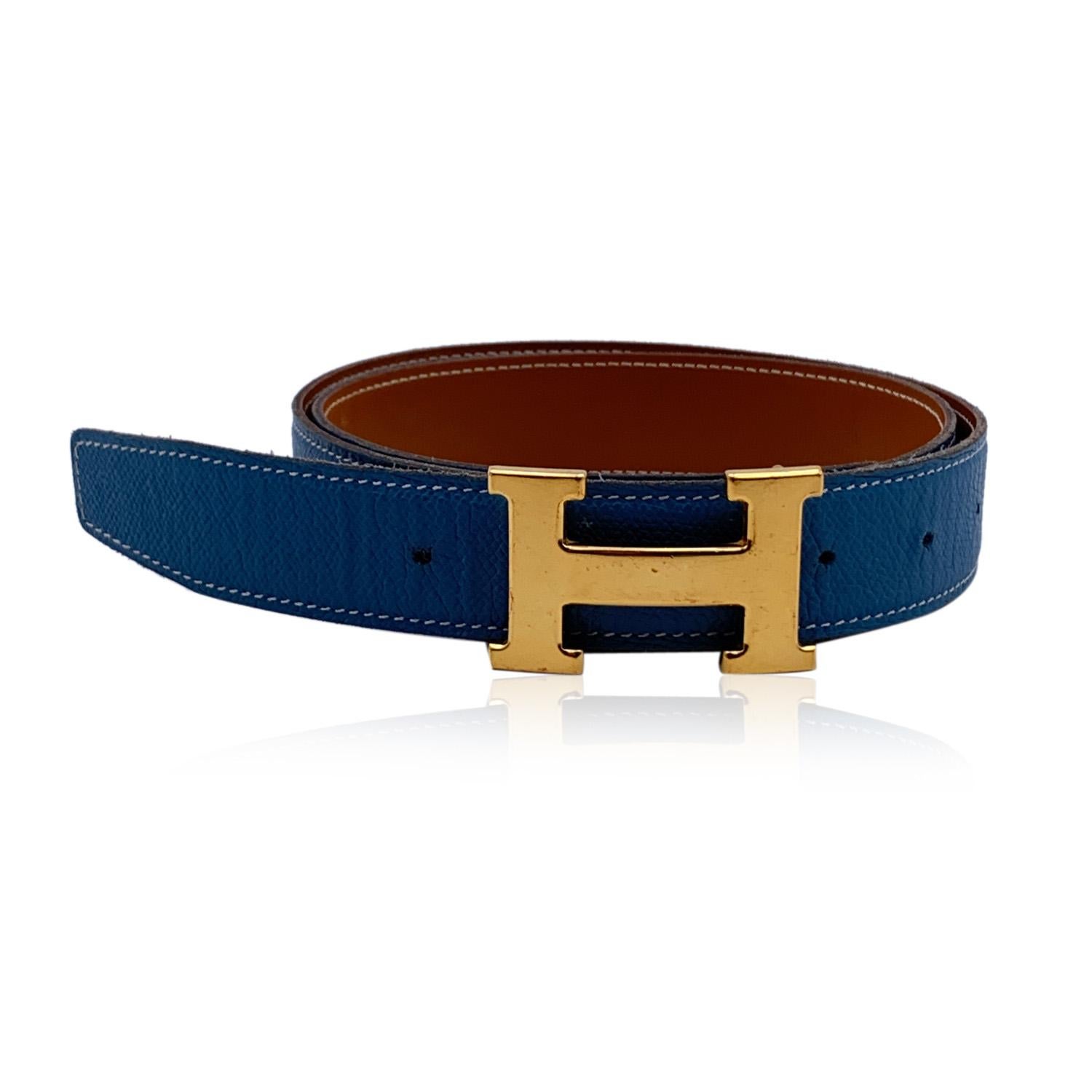 HERMES Reversible Belt. Blue leather on a side and Tan leather on the other side. Gold metal H Buckle. Size: 90. 'HERMES Paris - Made in France' engraved leather, 'J' blind stamp encased in a square (Year of production - 2006),'HERMES' engraved on