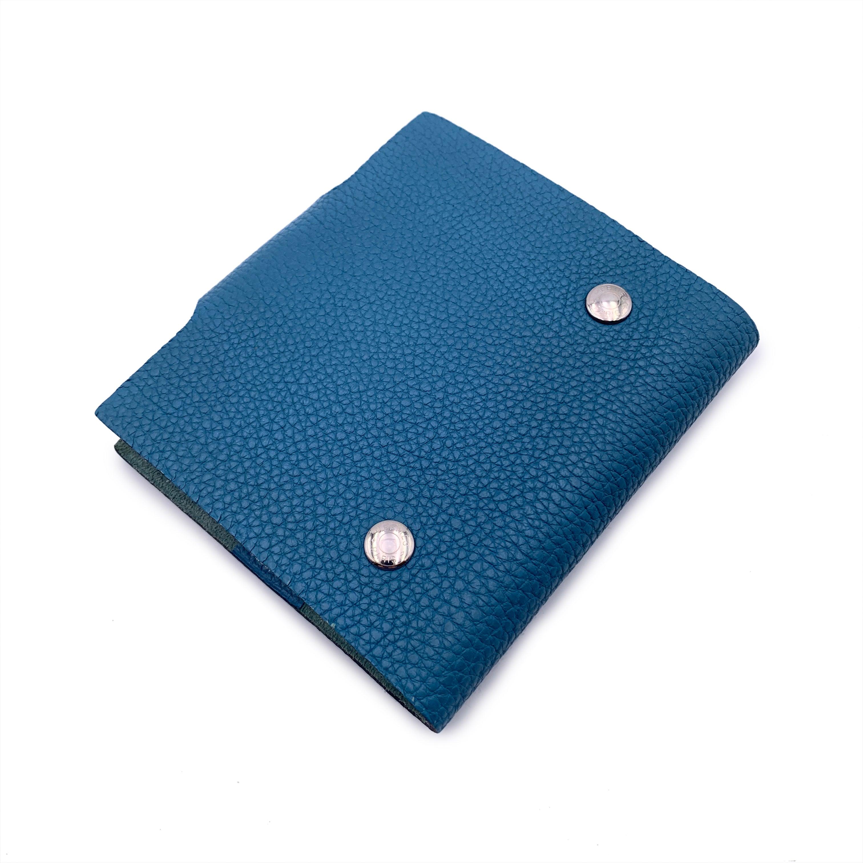 Hermès mini ULYSSE notebook cover in light blue Togo leather, palladium silver tone hardware. The cover opens with a snap to a suede interior. Original Hermes refill included. Logos / Tags: 'HERMES Paris - Made in France' tag inside, embossed data