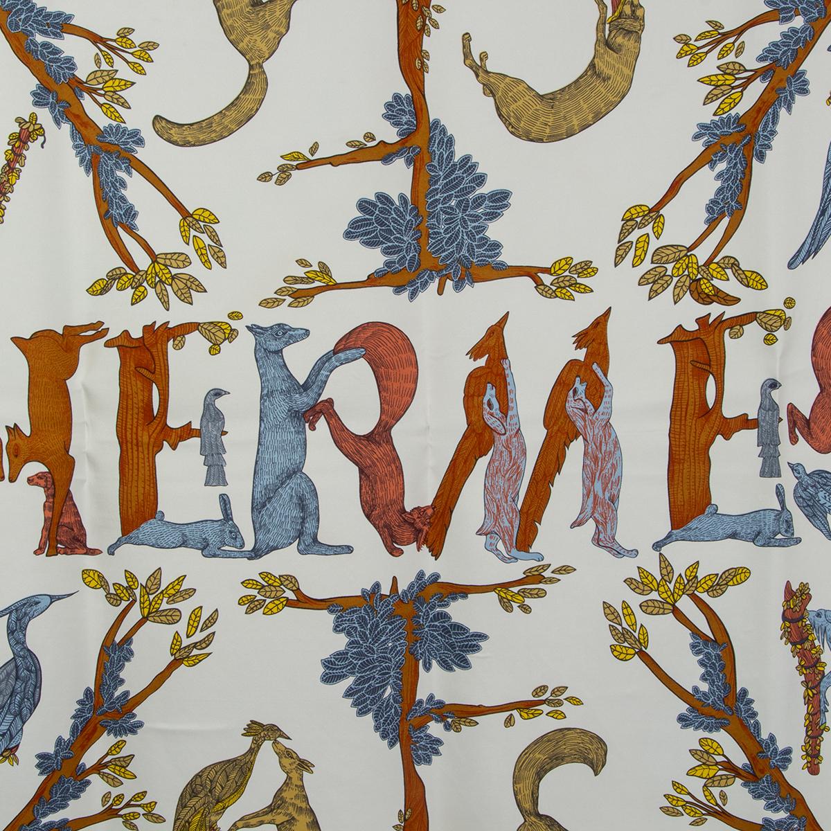 Hermes 'Alphabet 3 90' scarf by Annie Faivre in white silk twill (100%) with petrol blue border and details in brown, blue and green. Has been worn and is in excellent condition.

Width 90cm (35.1in)
Height 90cm (35.1in)