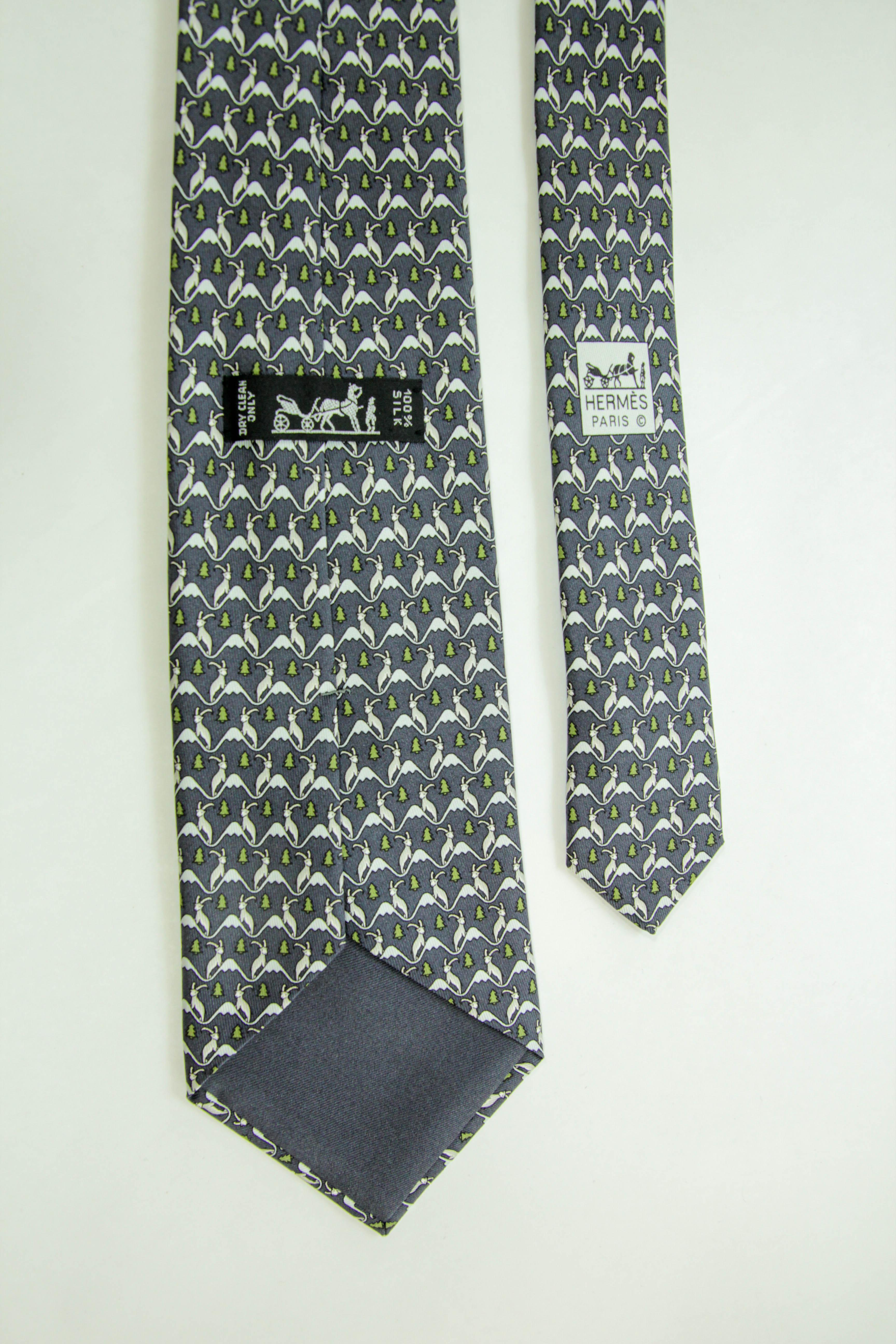 HERMES blue white green 100% silk goat mountain tree print formal tie.
HERMES blue white green 100% silk goat mountain tree print.
 Formal tie Reference: 5340 TA.
Brand: Hermes Material: Silk Color: Blue, Green Pattern: Cartoon Lining: Blue Silk