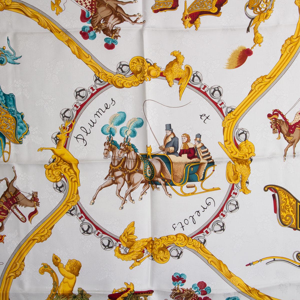 100% authentic Hermes 'Plumes et Grelots 90' scarf in white silk (100%) with holly jacquard. Navy blue border and details in gold, petrol,red brown and taupe. Has been worn and is in excellent condition.

Width 90cm (35.1in)
Height 90cm