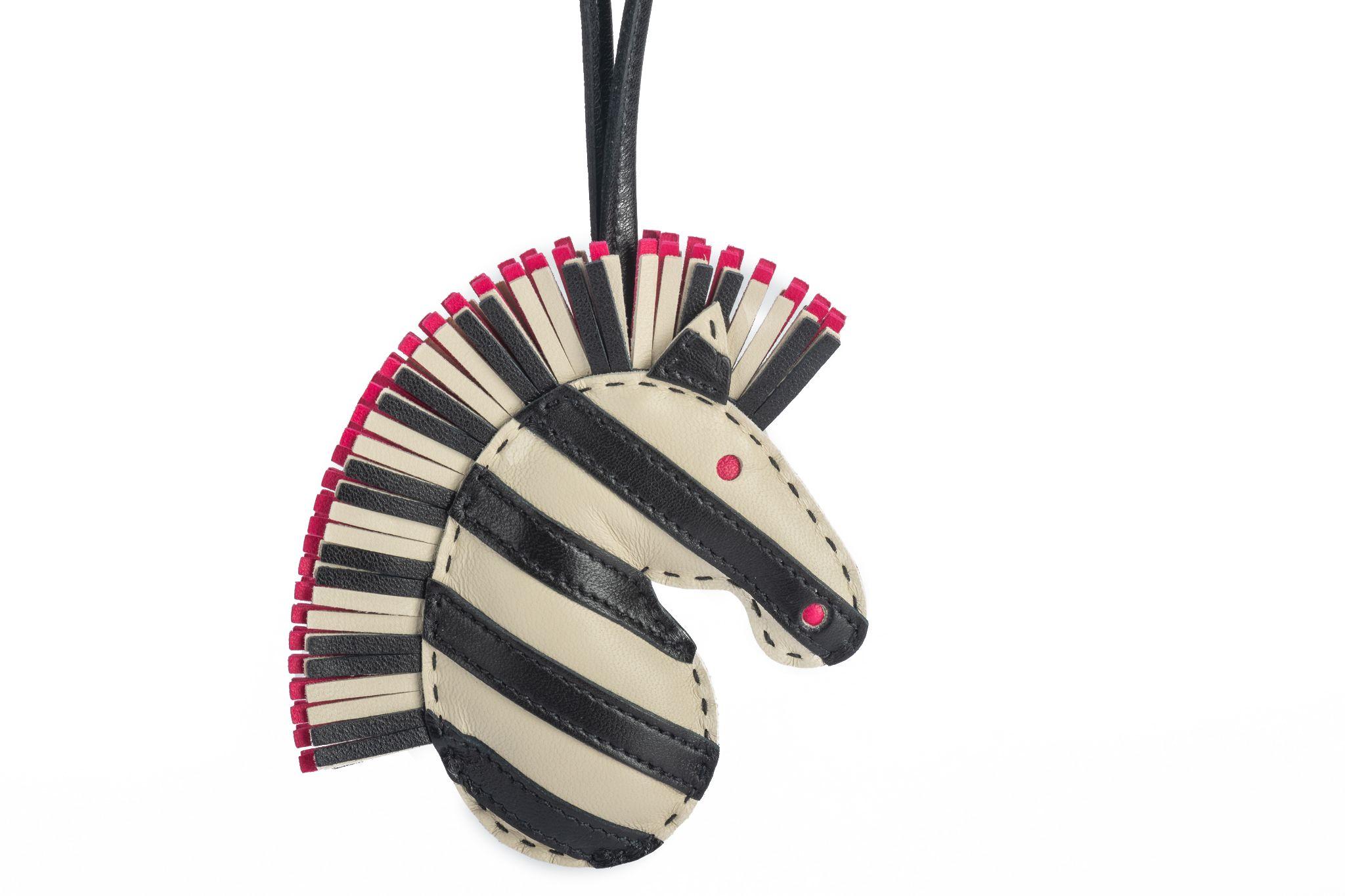 This GeeGee Savannah bag charm is  a combination of  black, craie and rose Mexico leather. Brand new in original box.