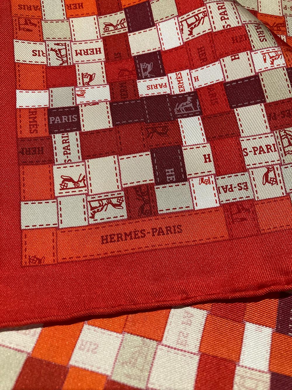 Hermes Red Bolduc Au Carre Silk Scarf in new condition. Original silk screen design c.2007 by Cathy Latham. features various shades of reds, whites, and grey with Hermes logo on right side. No stains smells or fabric pulls. Made in France. Hand