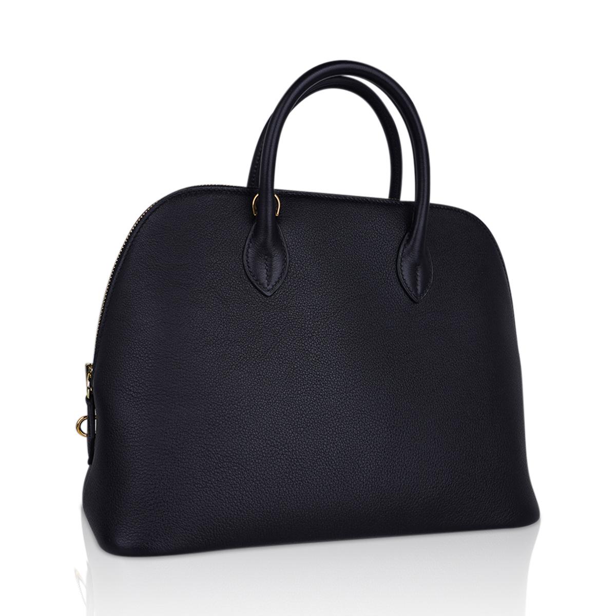Mightychic offers an Hermes Bolide 30 1923 sleek, clean and modern and easy to fall in love with bag.
Black with Gold hardware sets this beauty apart.
Taurillon Novillo leather has stepped to the forefront for good reason.
Bull leather, with a grain