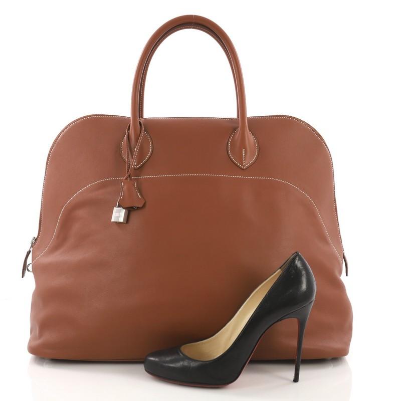 This Hermes Bolide Handbag Sikkim Relax 45, crafted from Fauve brown Sikkim Relax leather, features dual rolled leather handles, contrast stitching, protective base studs, and palladium-tone hardware. Its two-way zip closure opens to a beige fabric