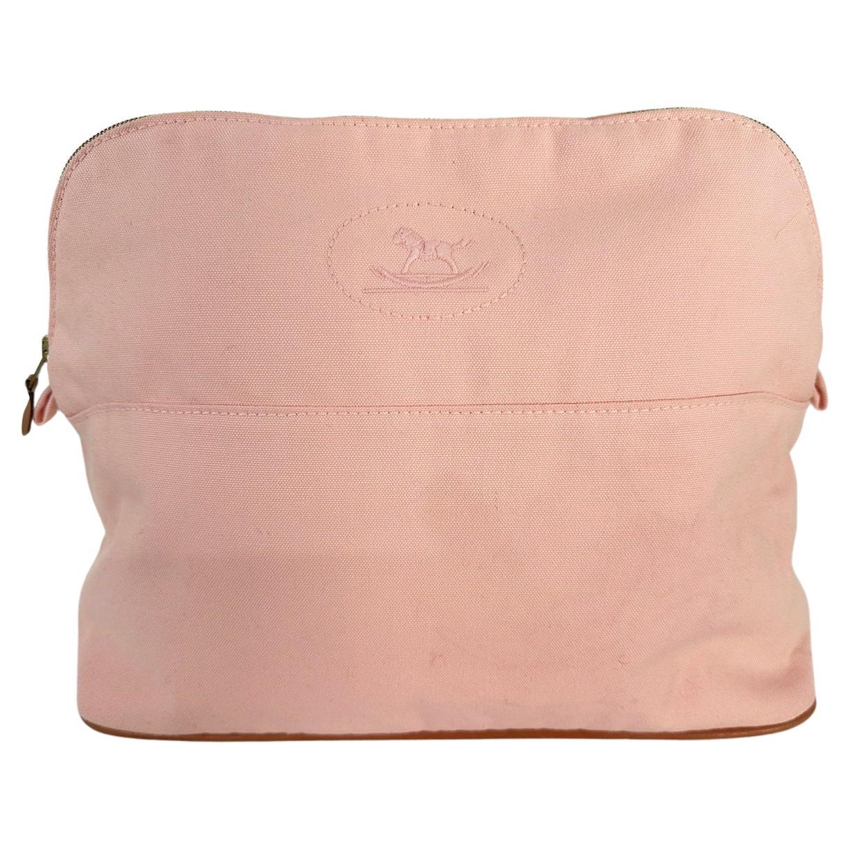 Hermes Bolide soft pink canvas cosmetic bag with rocking horse embroidery at the outside front. 2021. Lamb leather welt cord trim at bottom edge & gold zipper pull tab. Lined in pink with a single interior slip pocket. Large size 11