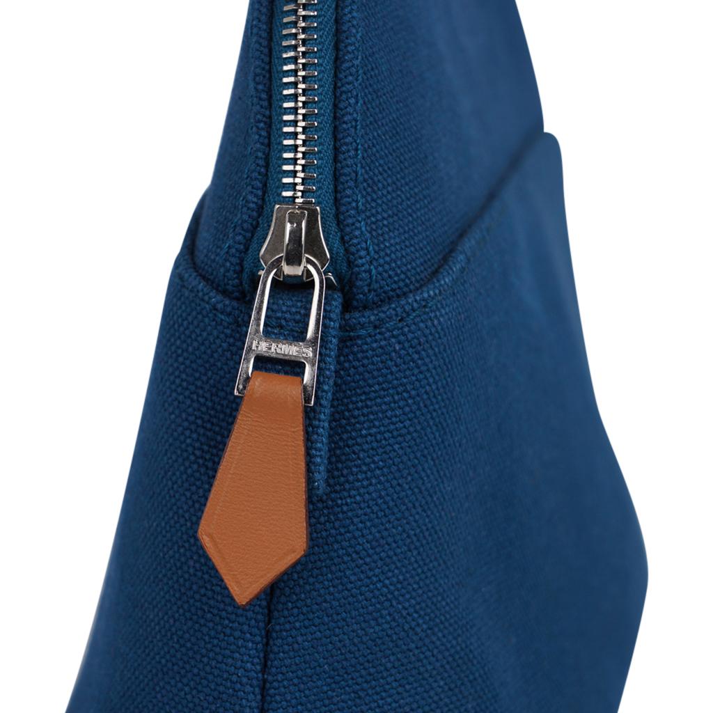 Hermes Bolide travel case mini model - Trousse de Voyage - featured in Bleu de Prusse cotton canvas.
Zipper toggle has lambskin leather pull and base has leather trim.   
This charming waterproof lined travel case has the embroidered H in front. 