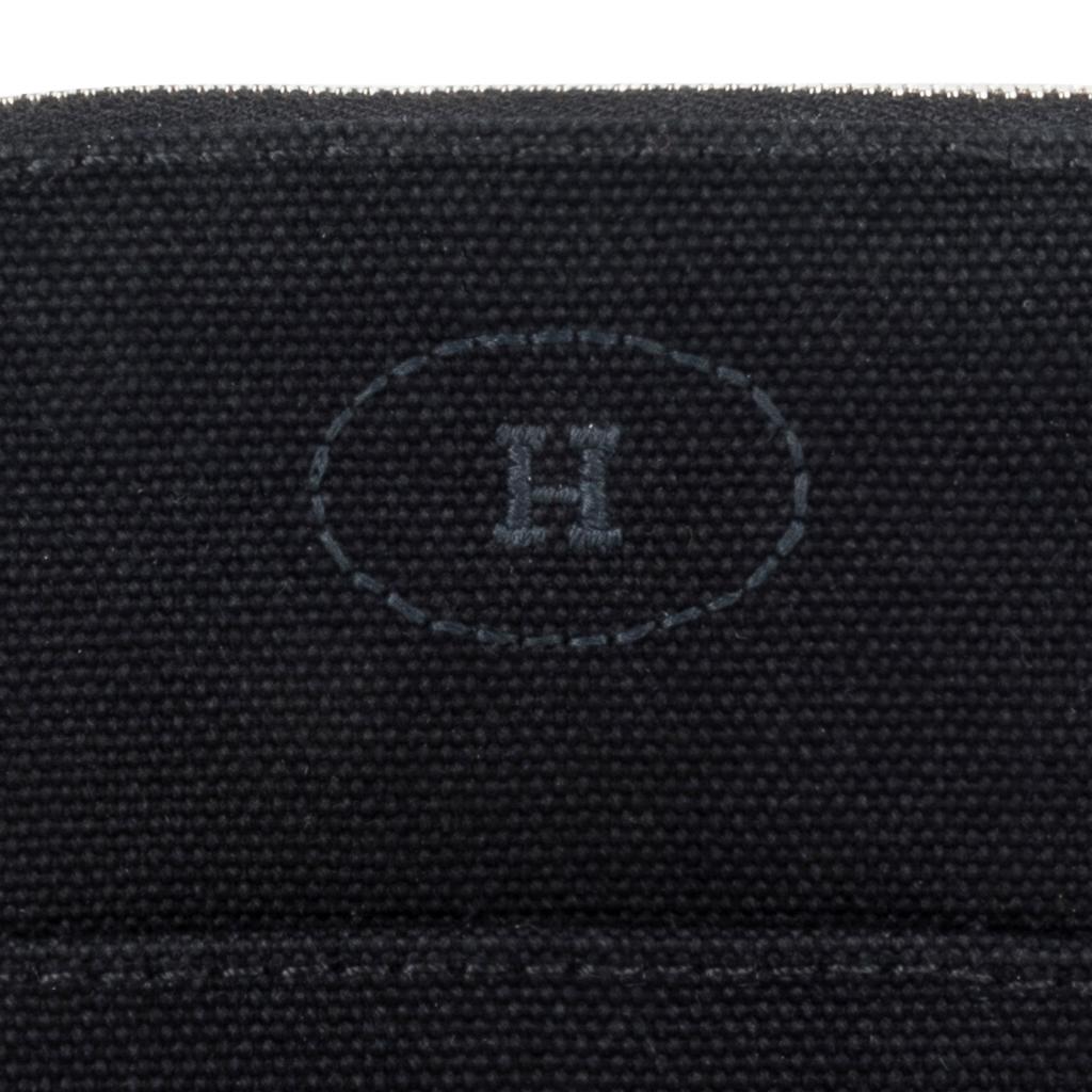 Guaranteed authentic Hermes Bolide travel case - Trousse de Voyage - featured in Black cotton canvas.
Zipper toggle has lambskin leather pull and base has leather trim.   
This charming waterproof lined travel case has the embroidered H in front. 