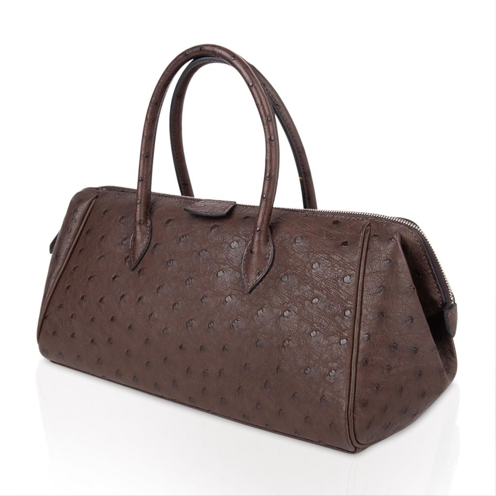 Mightychic offers a limited edition Hermes Bombay ostrich bag features rich Marron Fonce  in the perfect day to dinner size!
This soft rich deep brown is totally neutral and very chic with black. 
Double zippers open to the sides for easy