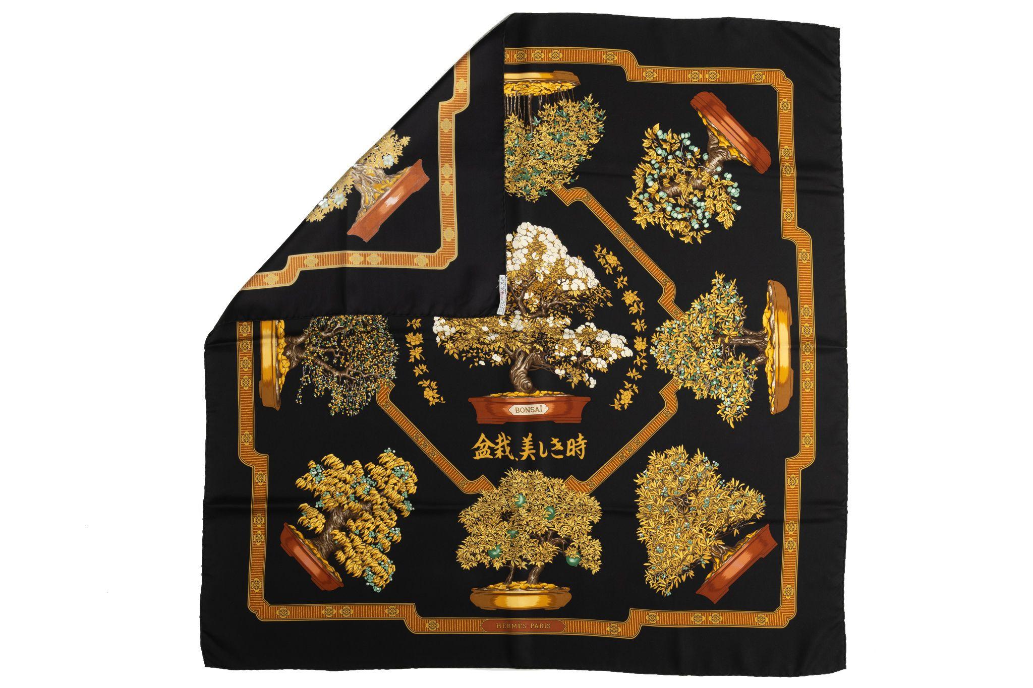 Hermès black and gold silk scarf with bonsai drawn on a black background. Includes original box.