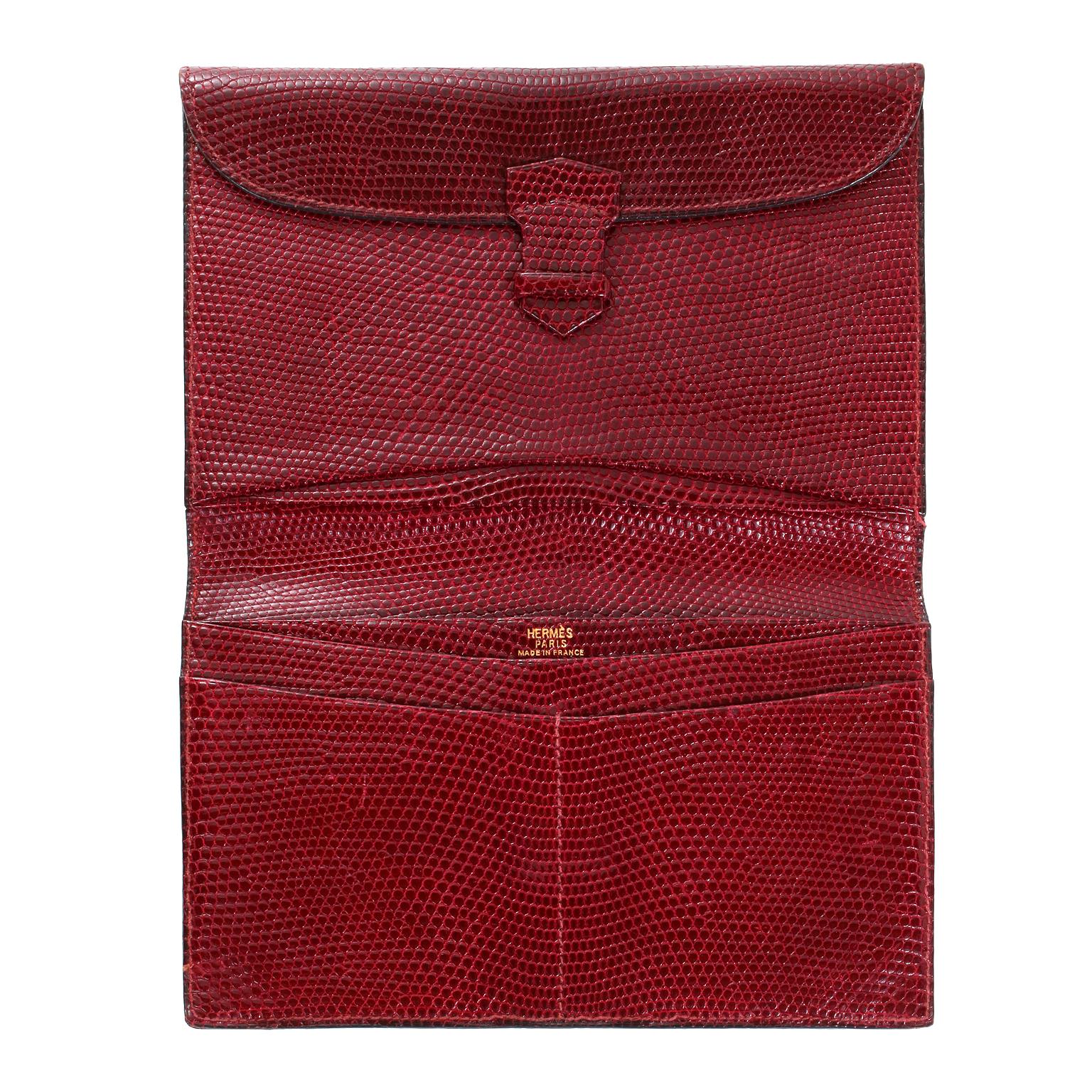 This authentic Hermès Bordeaux Lizard Billfold is in very good vintage condition with slight wear on the corners.  Suitable for either a man or a woman, this timeless wallet is a beautiful collectible.  
Bordeaux lizard skin billfold has an interior