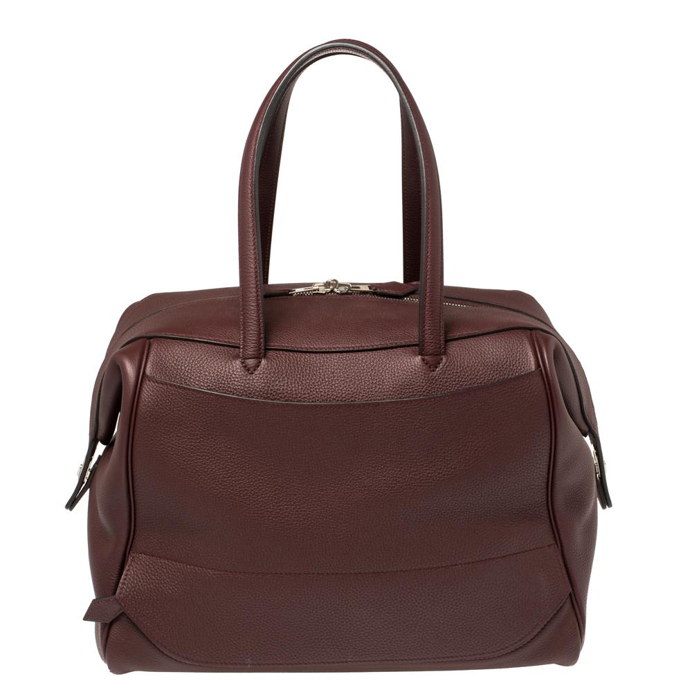 The Wallago Cabine 35 from Hermes is a bag that epitomizes creative excellence! With its understated charm and an elegant persona, it comes crafted from Bordeaux Togo leather and is an ideal companion for your escapades. The Wallago has been named