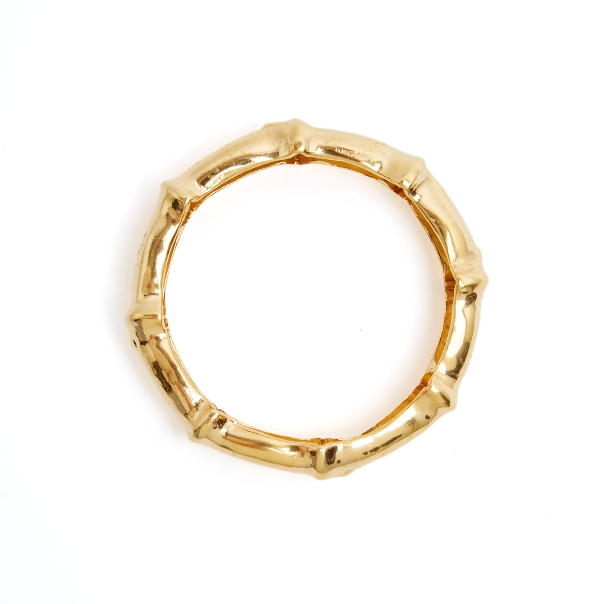 Hermès bracelet probably circa 1990 in hollow and rigid gold metal, Bamboo motif, signed. Inner diameter 6.3 cm, outer diameter approximately 7.8 cm, bracelet width 1.65 cm. The bracelet is super vintage and it has slight oxidation due to air (which