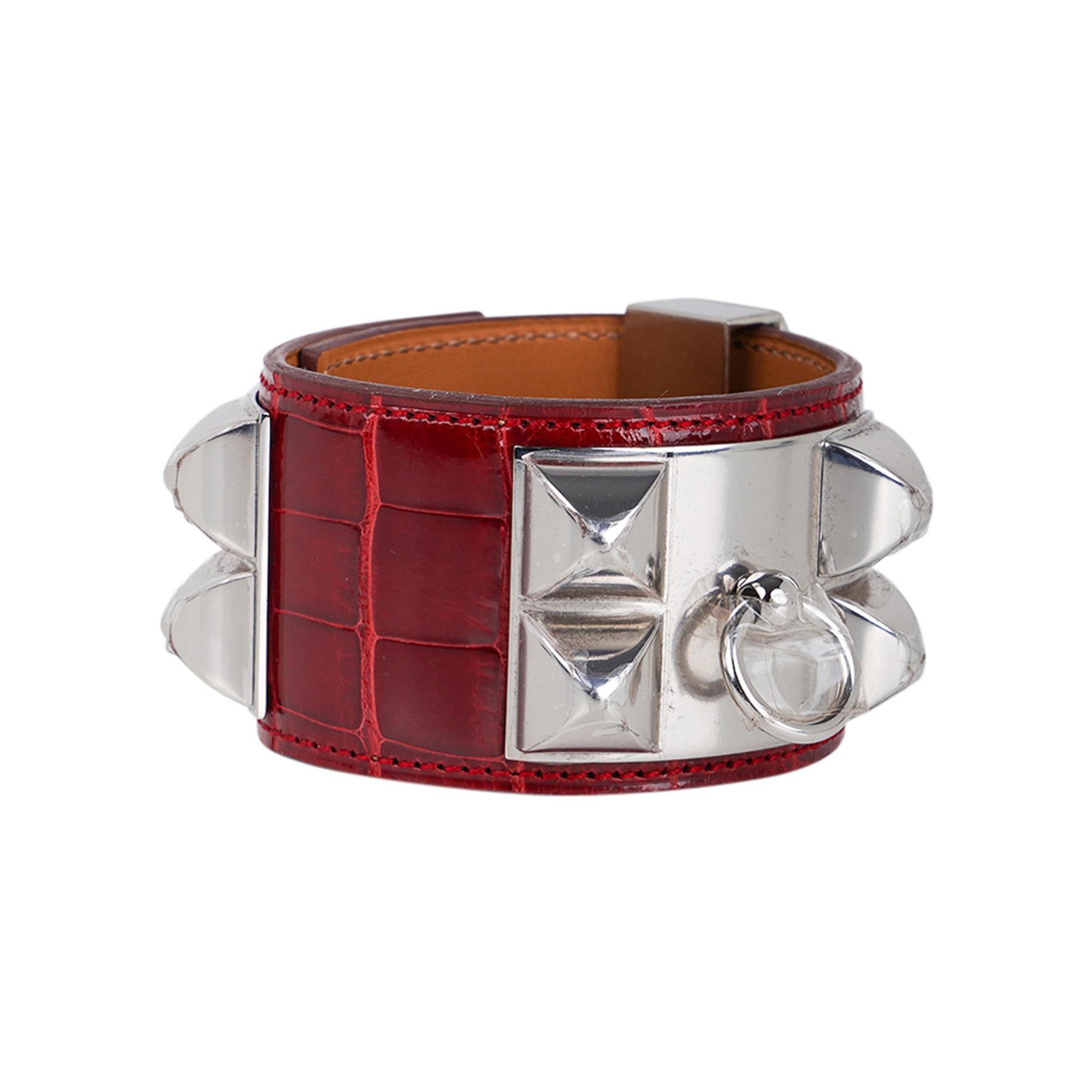 Hermes Collier de Chien CDC bracelet featured in Rouge Alligator.
Accentuated with Palladium hardware.
The chic and instantly recognizable Hermes iconic cuff bracelet.
This fabulous bold statement cuff is timeless and perfect to dress up or